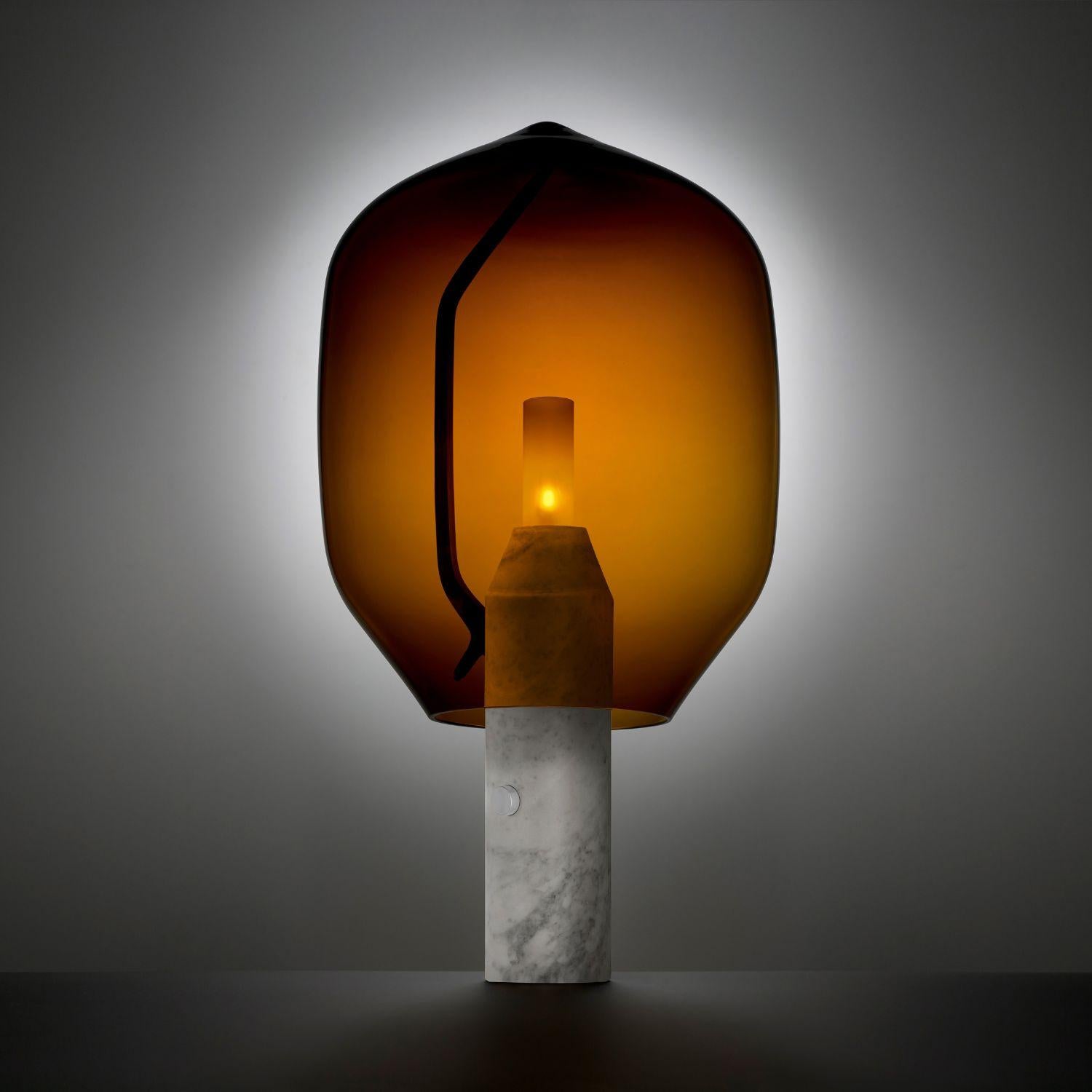 'Lighthouse’ Table Lamp in White Marble and Amber Glass for Established & Sons

An elegant equation of modern and traditional craftsmanship, the 'Lighthouse' balances a Venetian mouth blown glass shade on an industrially engineered aluminum arm,