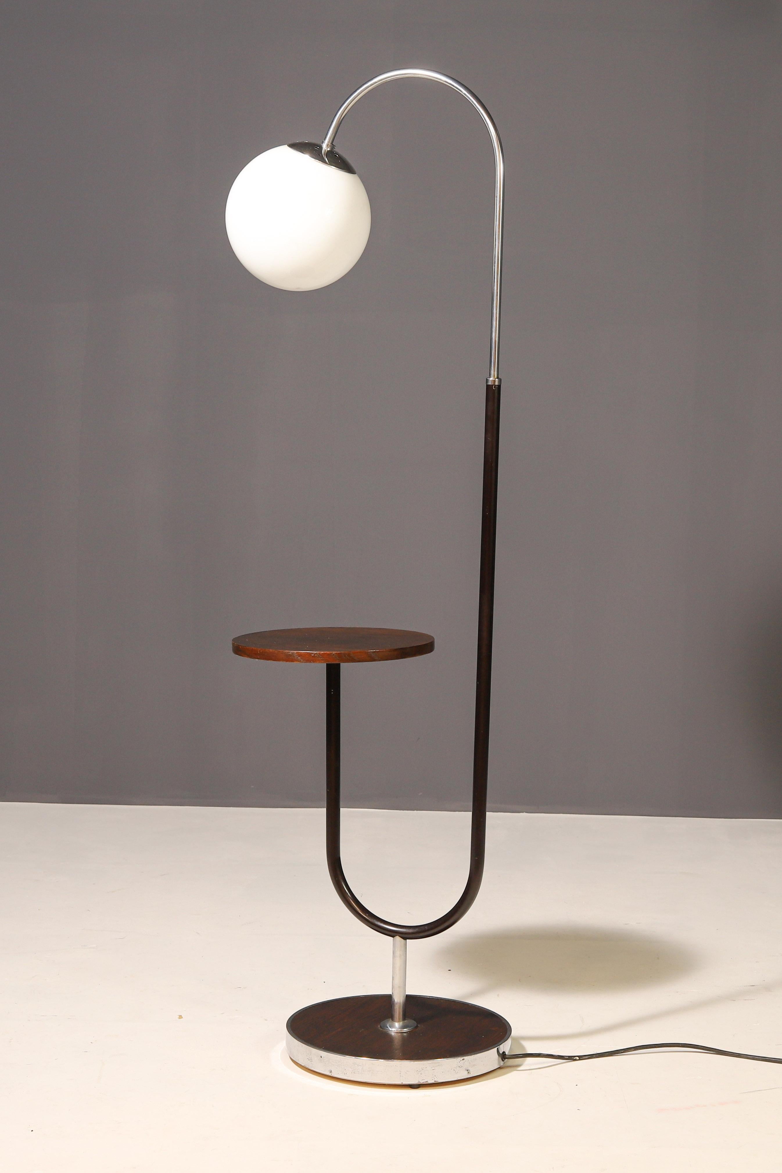 This elegant Art Deco floor lamp from the 1930s was designed by renowned Czech designer Jindřich Halabala for UP Závody Brno. The lamp blends functionality with sophisticated aesthetics, reflecting the characteristic features of interwar