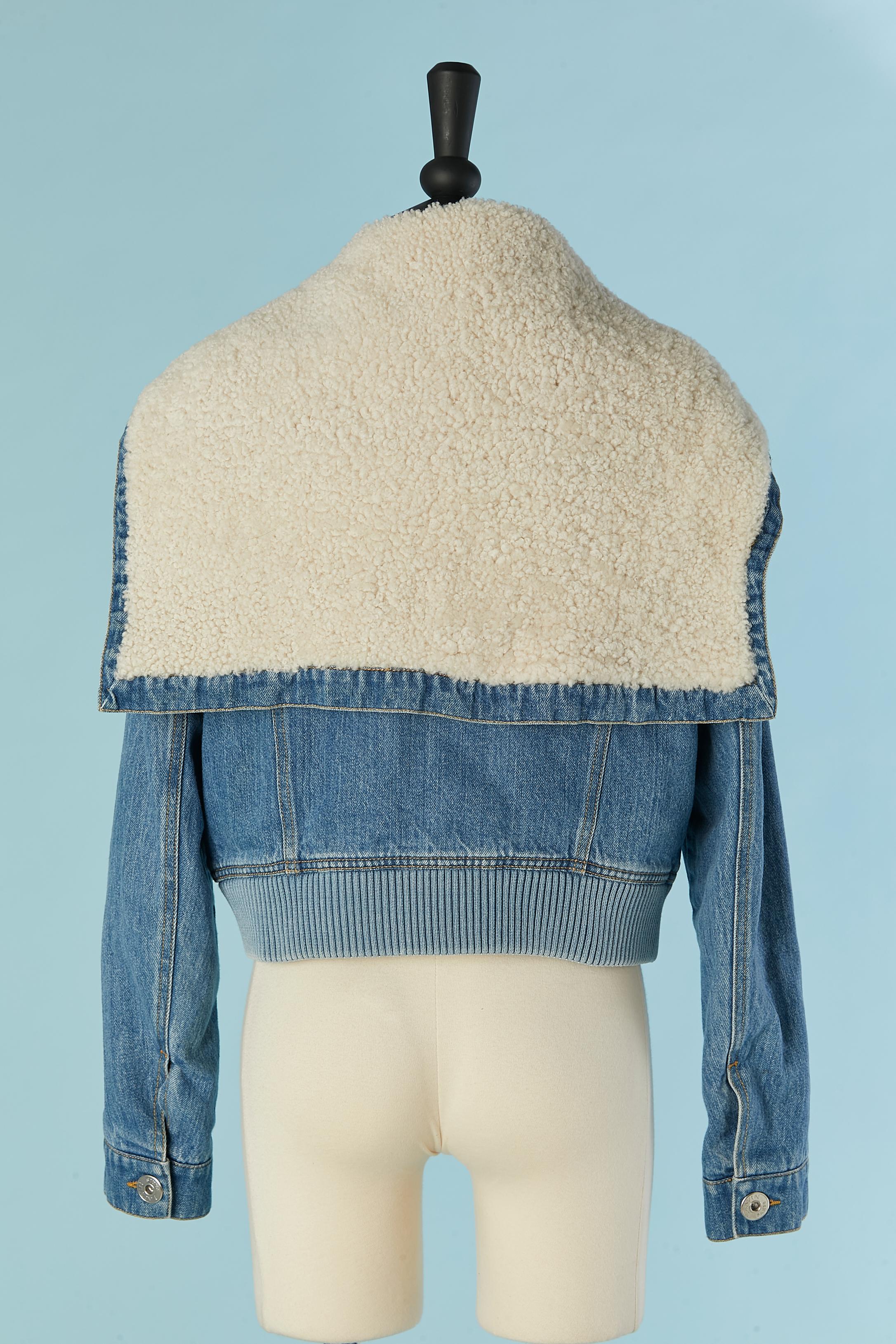 Lightly padded Denim jacket with wide off-white fur collar. Zip closure in the middle front with branded zip puller. 
Branded buttons on cuffs. Pockets on both side. Branded polyester lining. The collar can be rolled and attached with denim belt.