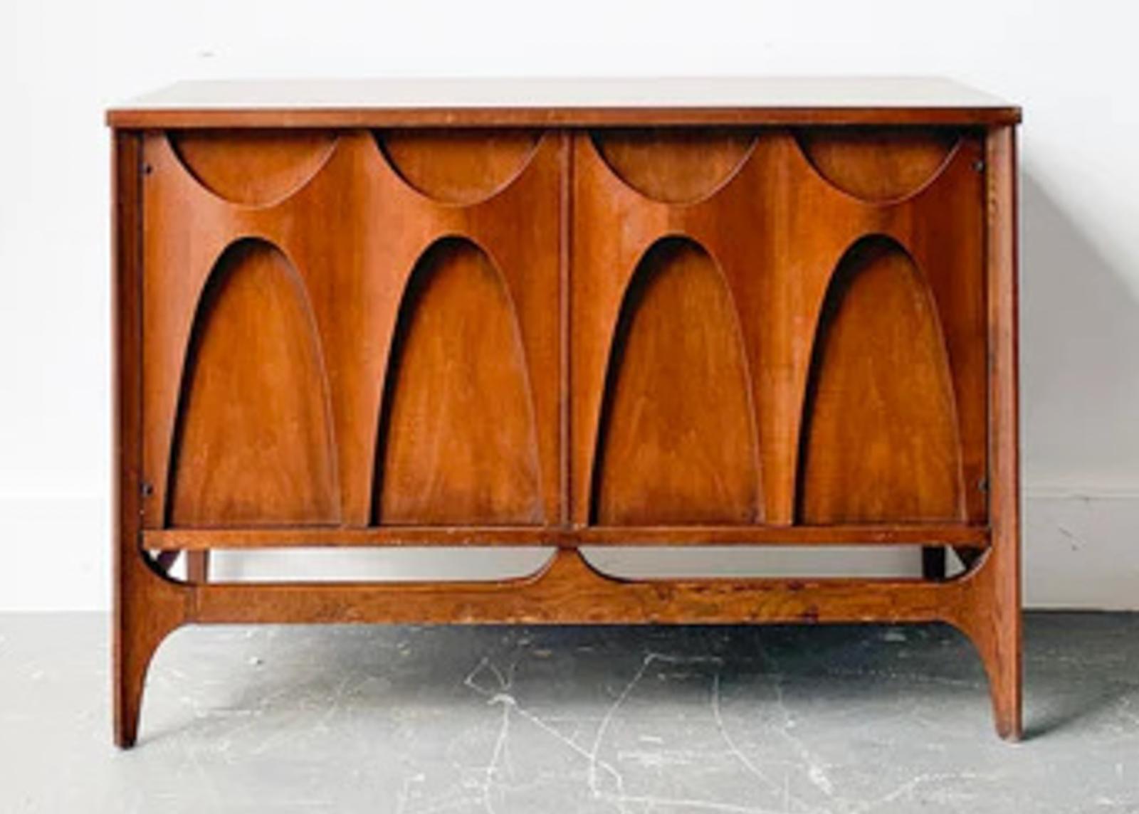 This fantastic buffet or media cabinet was built in the 1970s by high-end manufacturer Broyhill for their Brasilia line of furntiure. Since then, the Brasilia line has become more desirable, and original sets are difficult to come by. Featuring