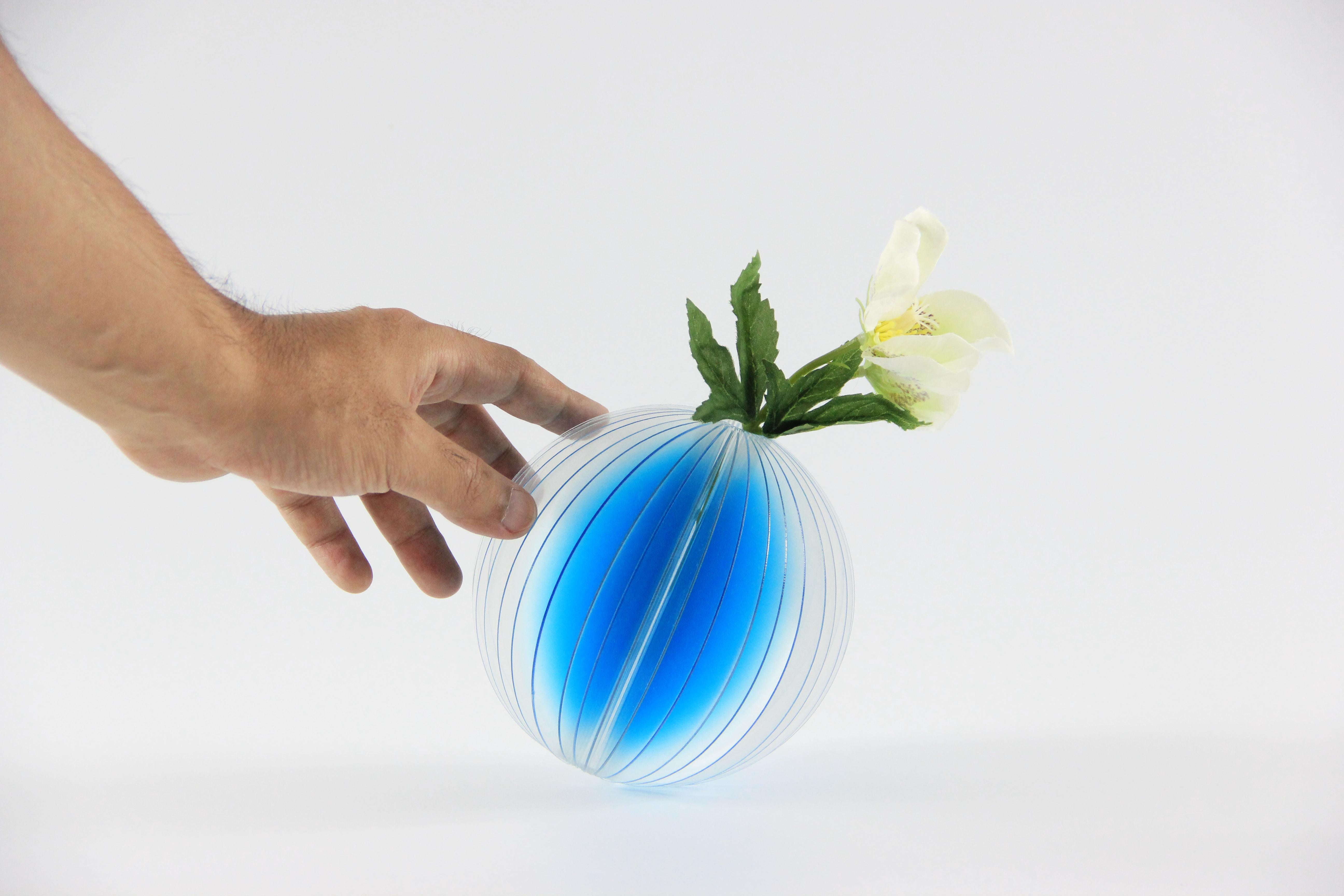 Lightness vases are inspired by an accidental scene. When light is projected into the space which is layered , the wonderful imagination is beginning. The vases feature gradations of colors that optically change depending on the light hitting