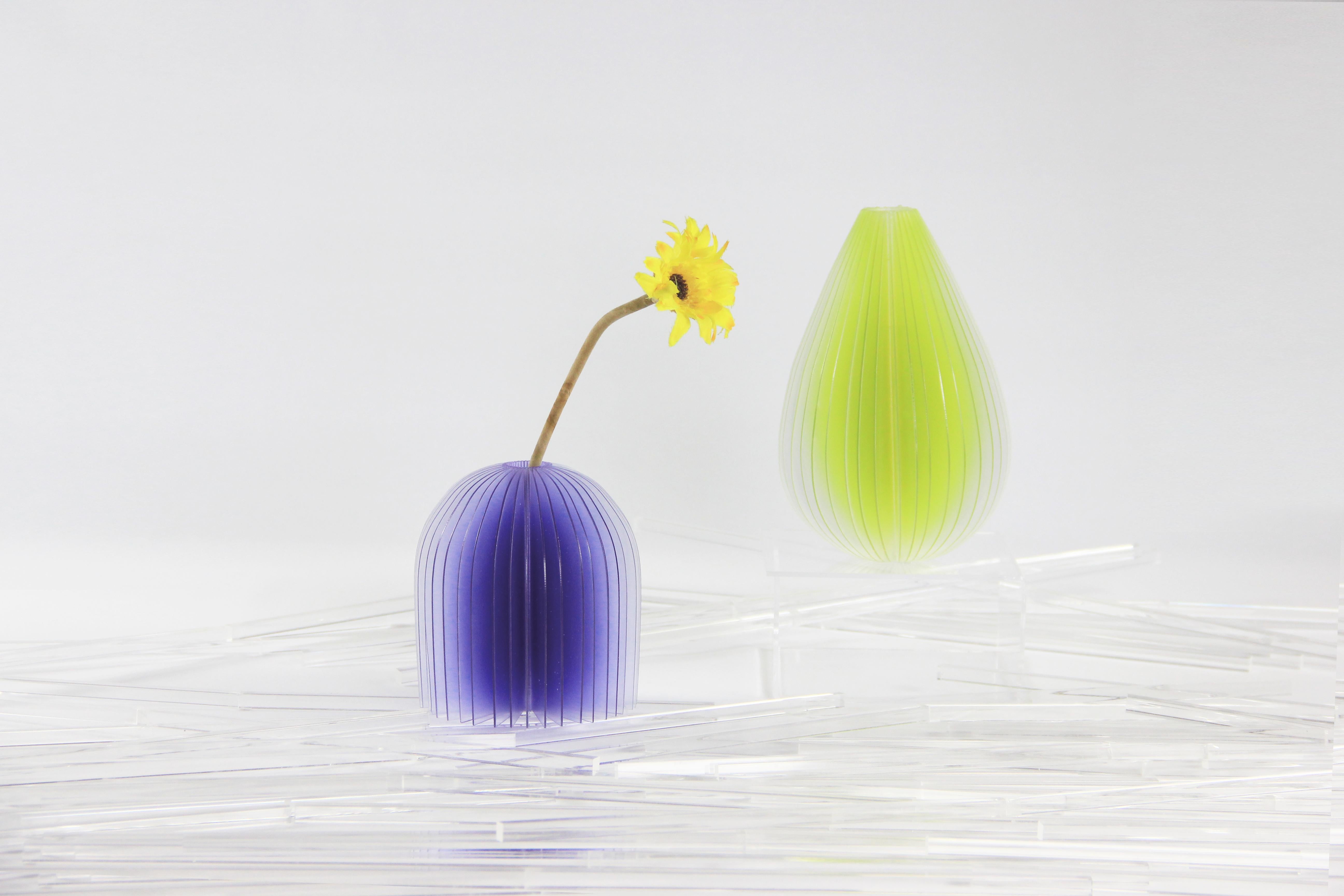 Lightness vases are inspired by an accidental scene. When light is projected into the space which is layered , the wonderful imagination is beginning. The vases feature gradations of colors that optically change depending on the light hitting