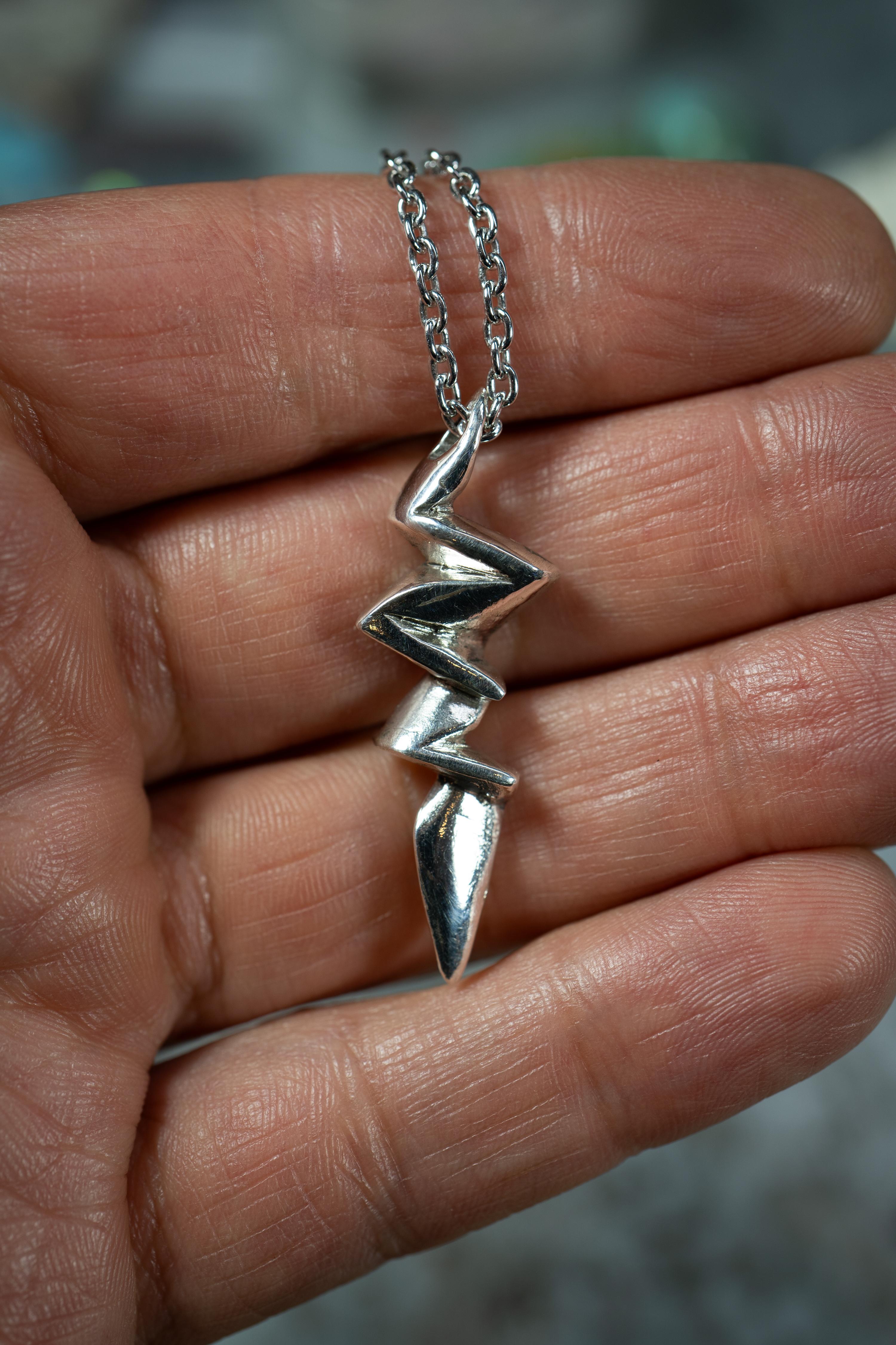 Lightning Bolt pendant by Ken Fury is hand-carved and cast. This pendant symbolizes nature's raw power, beauty, and transformative and illuminating qualities.

Available in 10K Solid White or Yellow Gold. Send a message to specify which one you