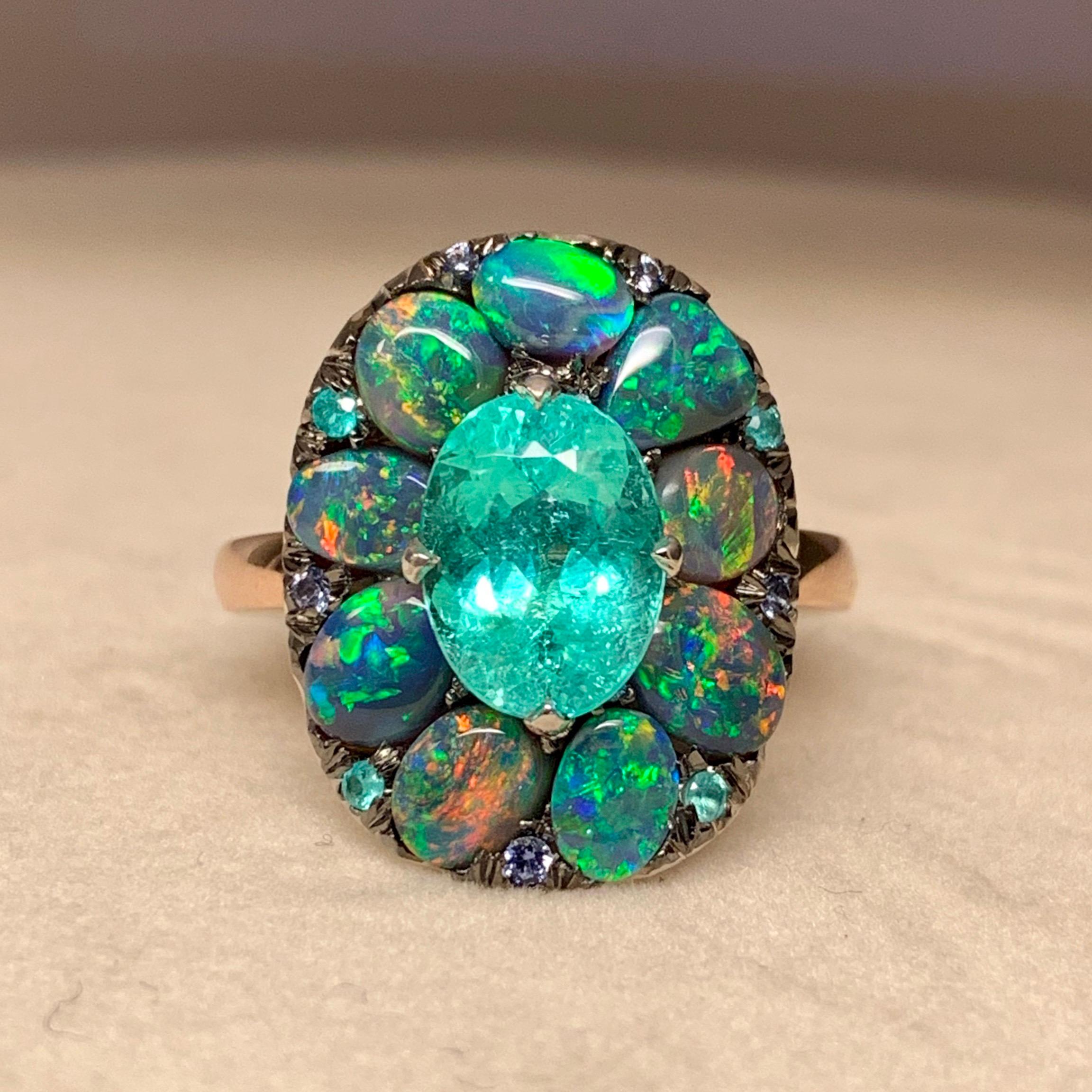 One of a kind ring custom made with centerstone from you,( Nancy ;-)))) 18K Rose & White gold 12,6 g.  set with a Paraiba Tourmaline centerstone 2,54 ct ., Black Opal cabochons from Lightning Ridge 2,58 ct.,  brilliant-cut unheated blue sapphire