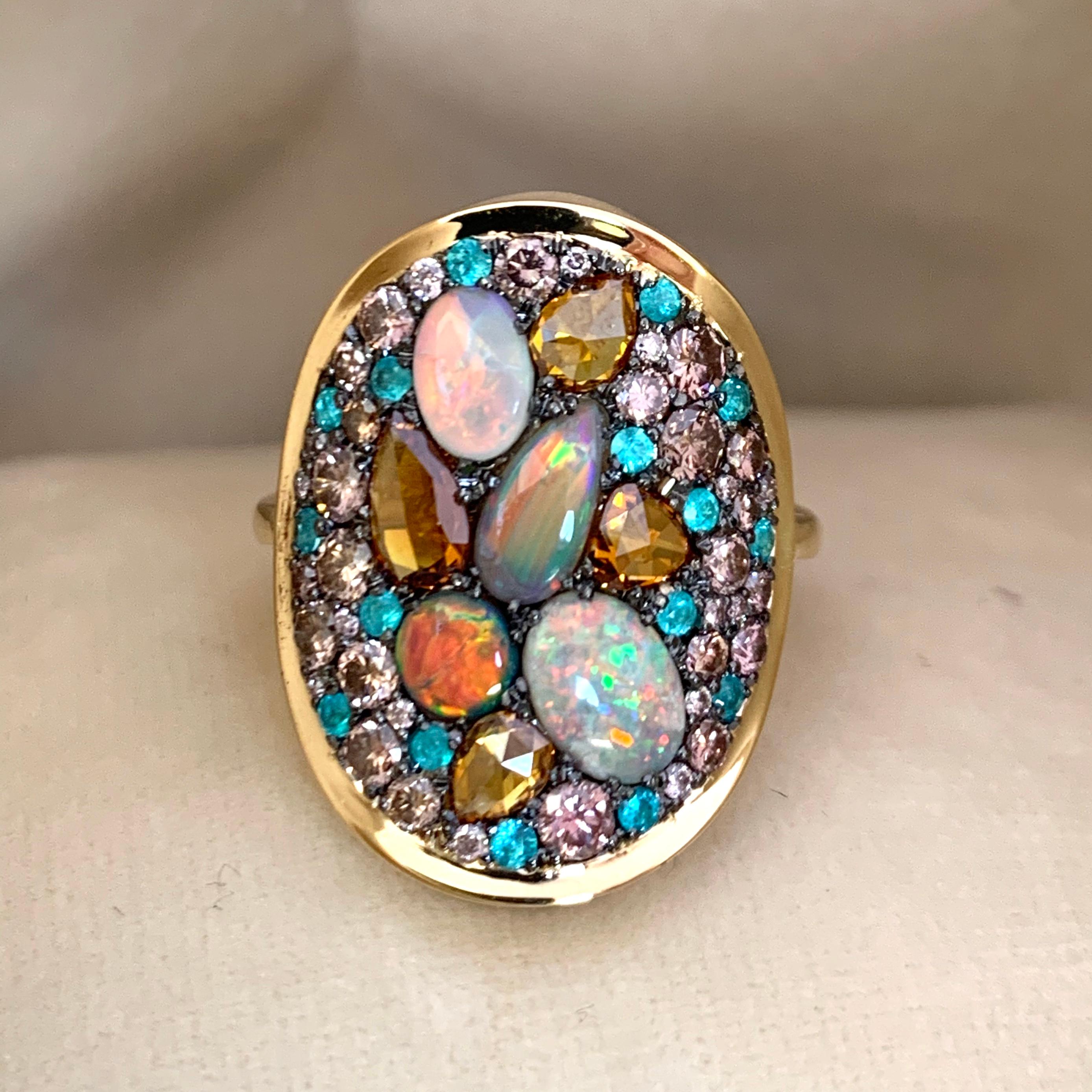 One of a kind 'Starstruck' ring handmade in Belgium by jewellery artist Joke Quick, in 18K yellow gold 12.2 g & blackened sterling silver 1.7 gram (The stones are set on silver to create a black background for the stones.)
2 Black Opals and 2 Dark