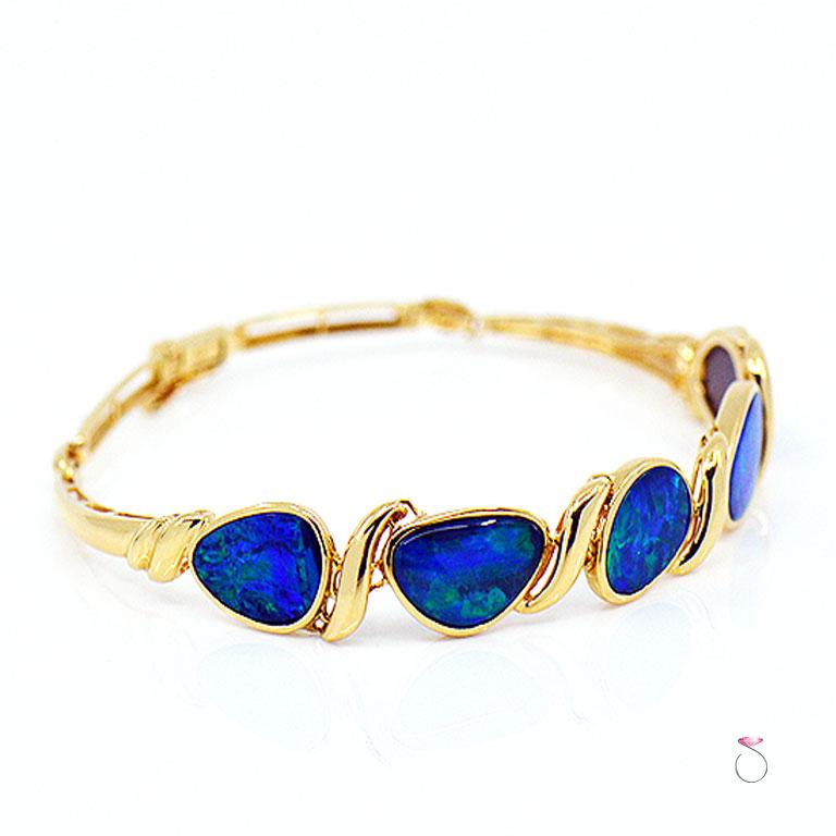 Absolutely stunning 14k yellow gold black Australian lightning ridge Opal bracelet. This gorgeous bracelet is beautifully crafted in 14K yellow gold and set with five large Australian lightning ridge opals. The stunning Opals displays a beautiful