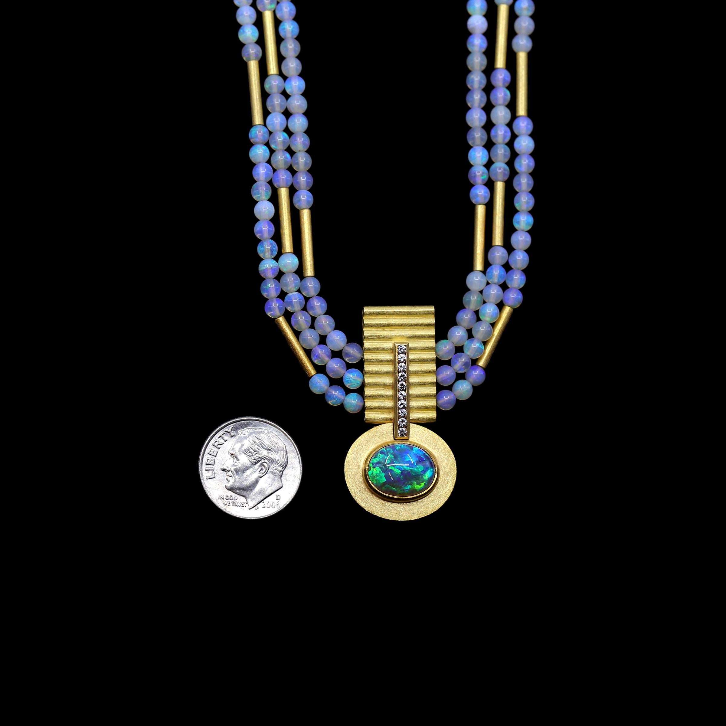 A wearable work of art by German jewellery maker Eva Steinberg, the one-of-a-kind Heavenly Opal Strands Necklace showcases a rare and exceptional cabochon-cut 4.44 carat Lightning Ridge black opal crystal oval framed in 21k yellow gold. The subtly