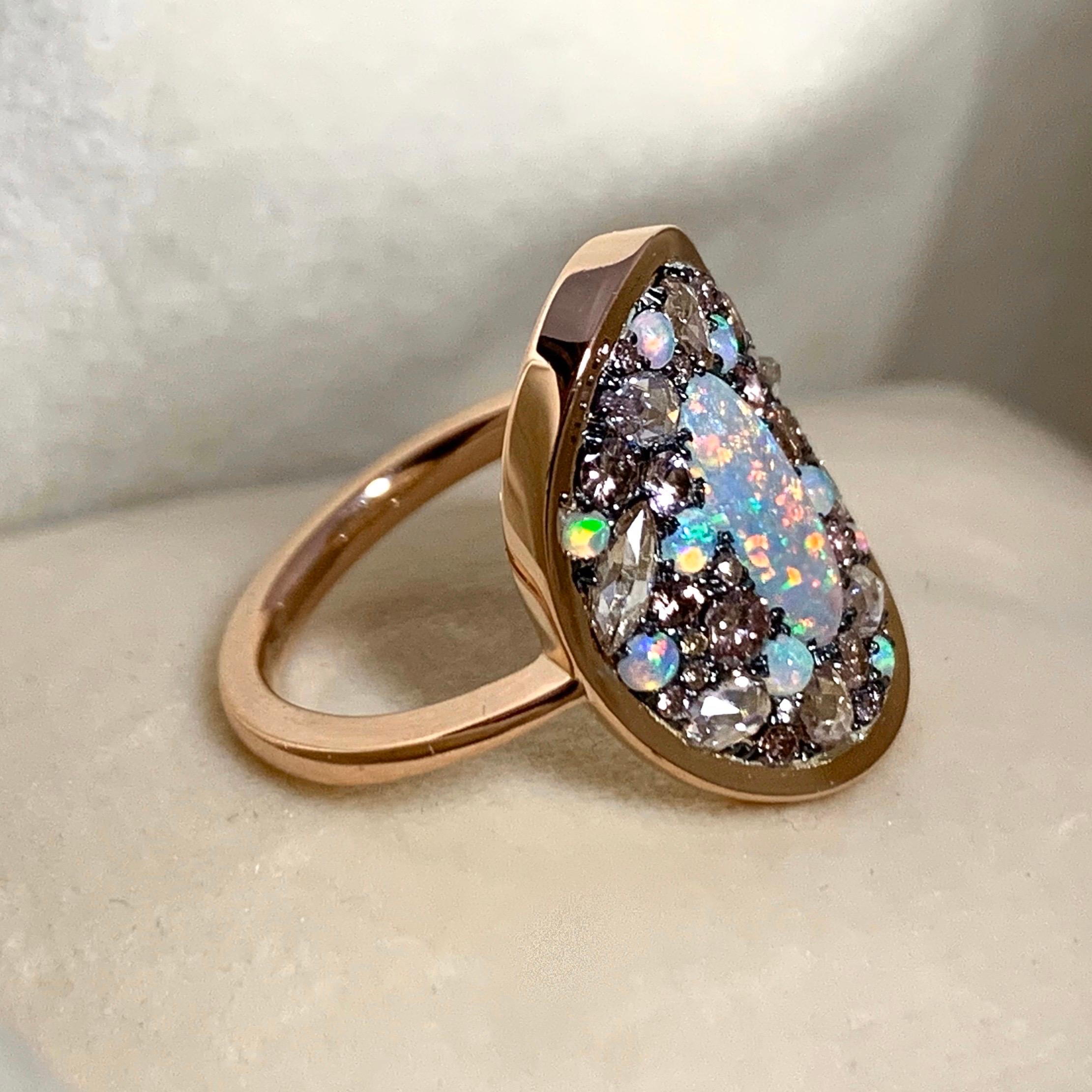 One of a kind ring handmade in Belgium by jewellery artist Joke Quick, in 18K rose gold 5,4 g & blackened sterling silver 2 g (The stones are set on silver to create a black background for the stones.)
Dark Opal centerstone from Lightning Ridge Mine