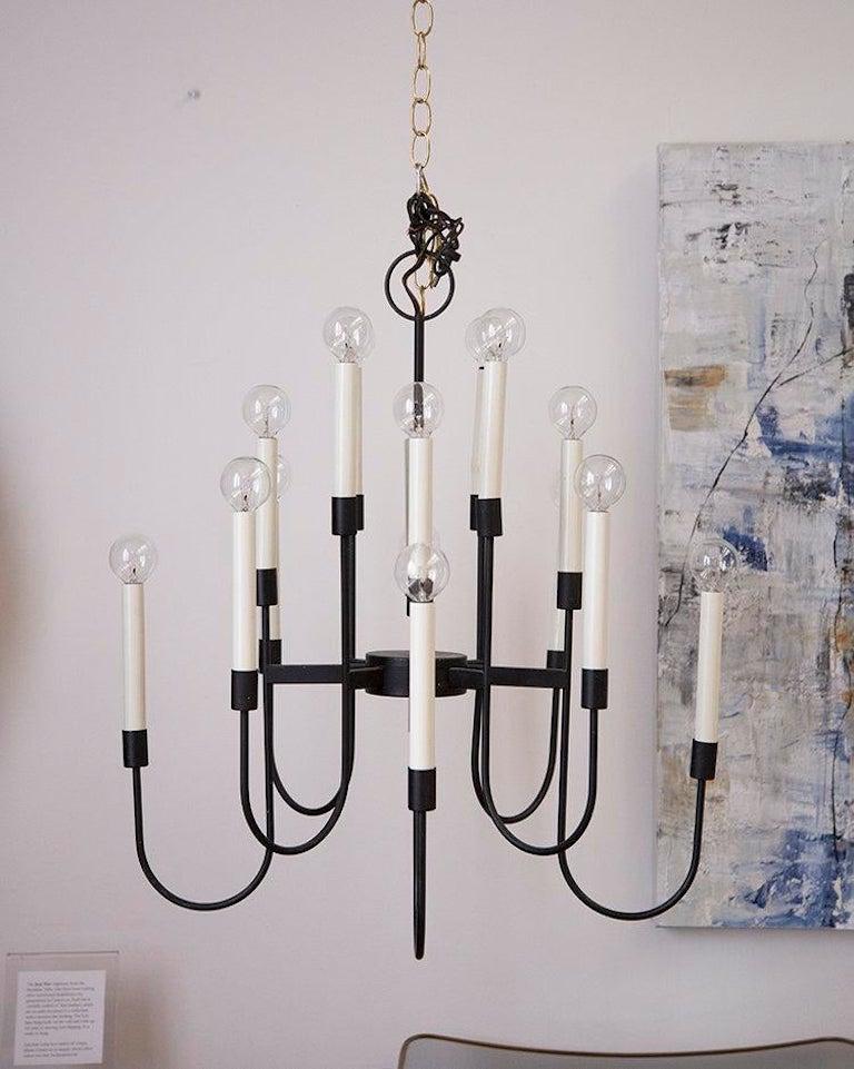 A phenomenal chandelier by Lightolier featuring a black metal frame and 16 arms, elegantly staggered in height. We love the departure from metallic this modern light fixture provides.

USA, 1960s.