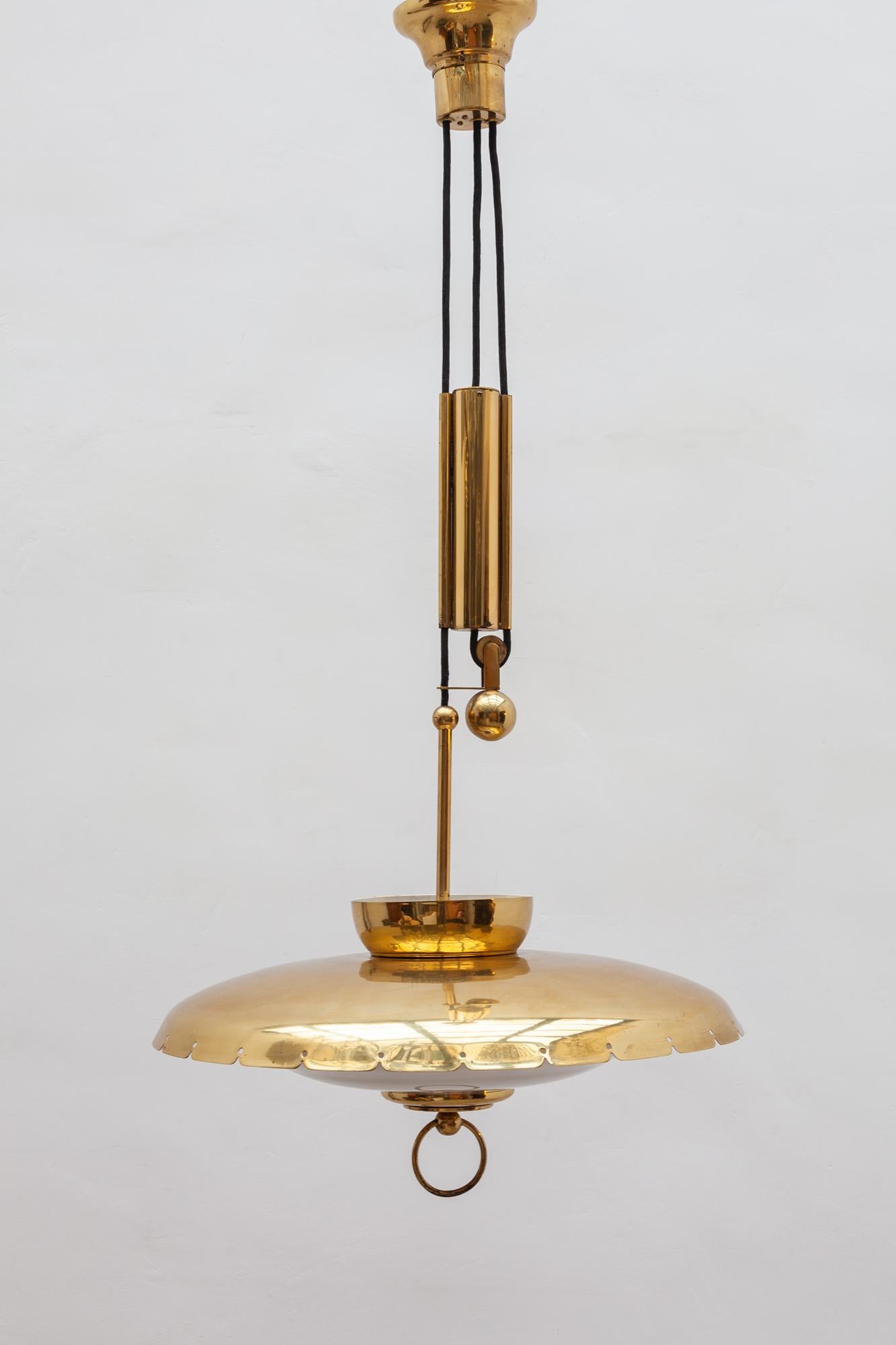 Gerald Thurston pull down pendant with glass shade and perforated brass elements a beautiful rare pendant 1950s.