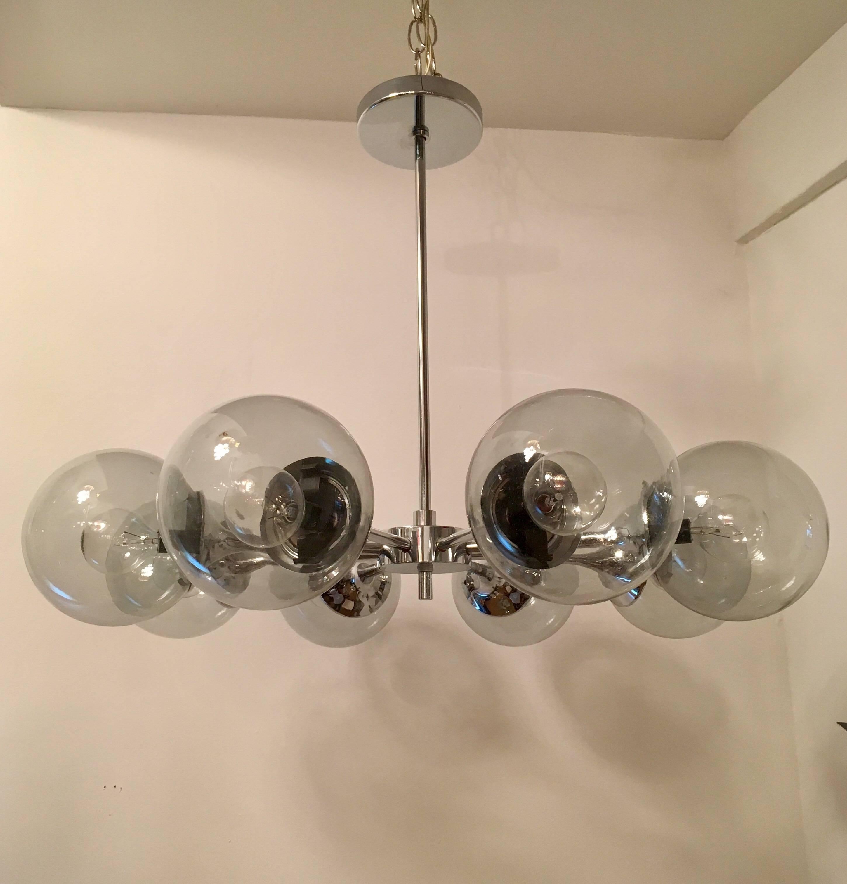 An original 1960s eight light polished chrome and lightly smoked gray glass globes sputnik by the famed American lighting company, lightolier. Newly rewired. Original label.