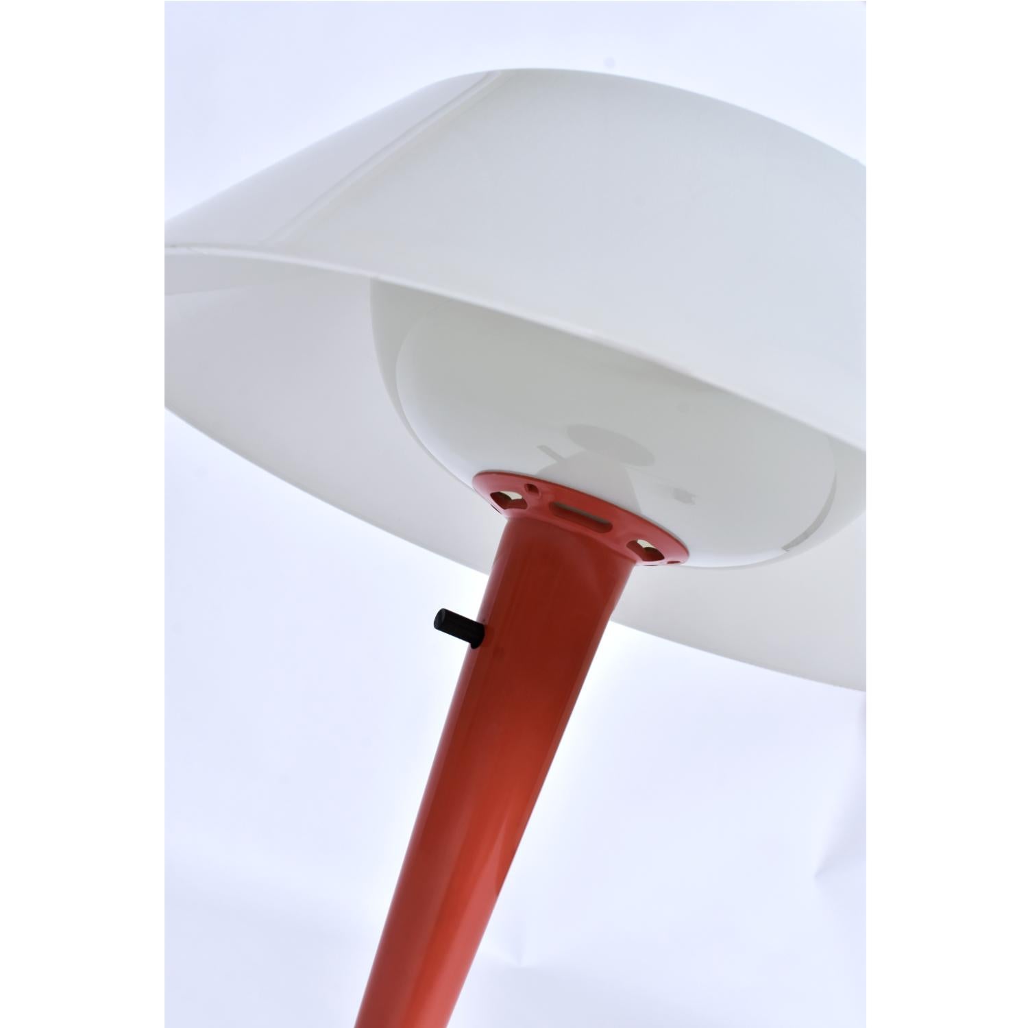 Unique table lamp from famed producer, Lightolier. Designed by Gerald Thurston, the lamp has a few Lightolier labels present. The minimalist design cuts a clean silhouette with its tapered cone shape. A mushroom shade adorns the top and is