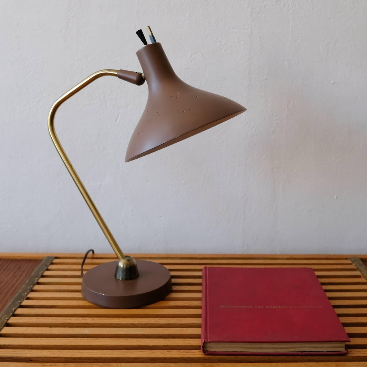 Lightolier desk lamp with perforated metal pivoting shade. Includes the original and rarely-seen metal bulb diffuser. Brass arm and handle. Original finish in great condition.