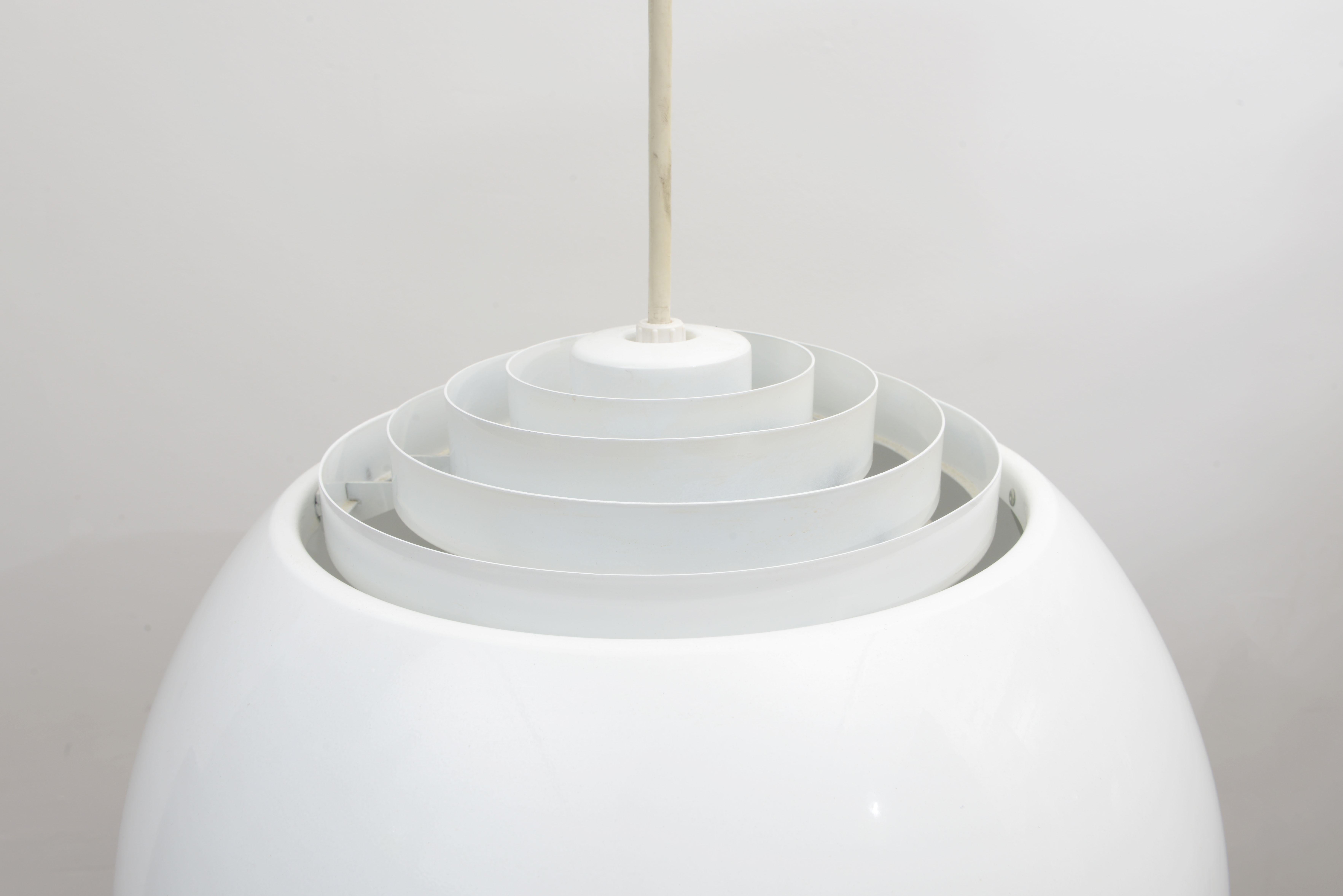 This is one awesome Lightolier dome pendant lamp 1960s. Signed with Lightolier sticker in canopy. This pendant is lamp is made of metal and it features staggered concentric circles allowing passing light to escape thought the top and a glass