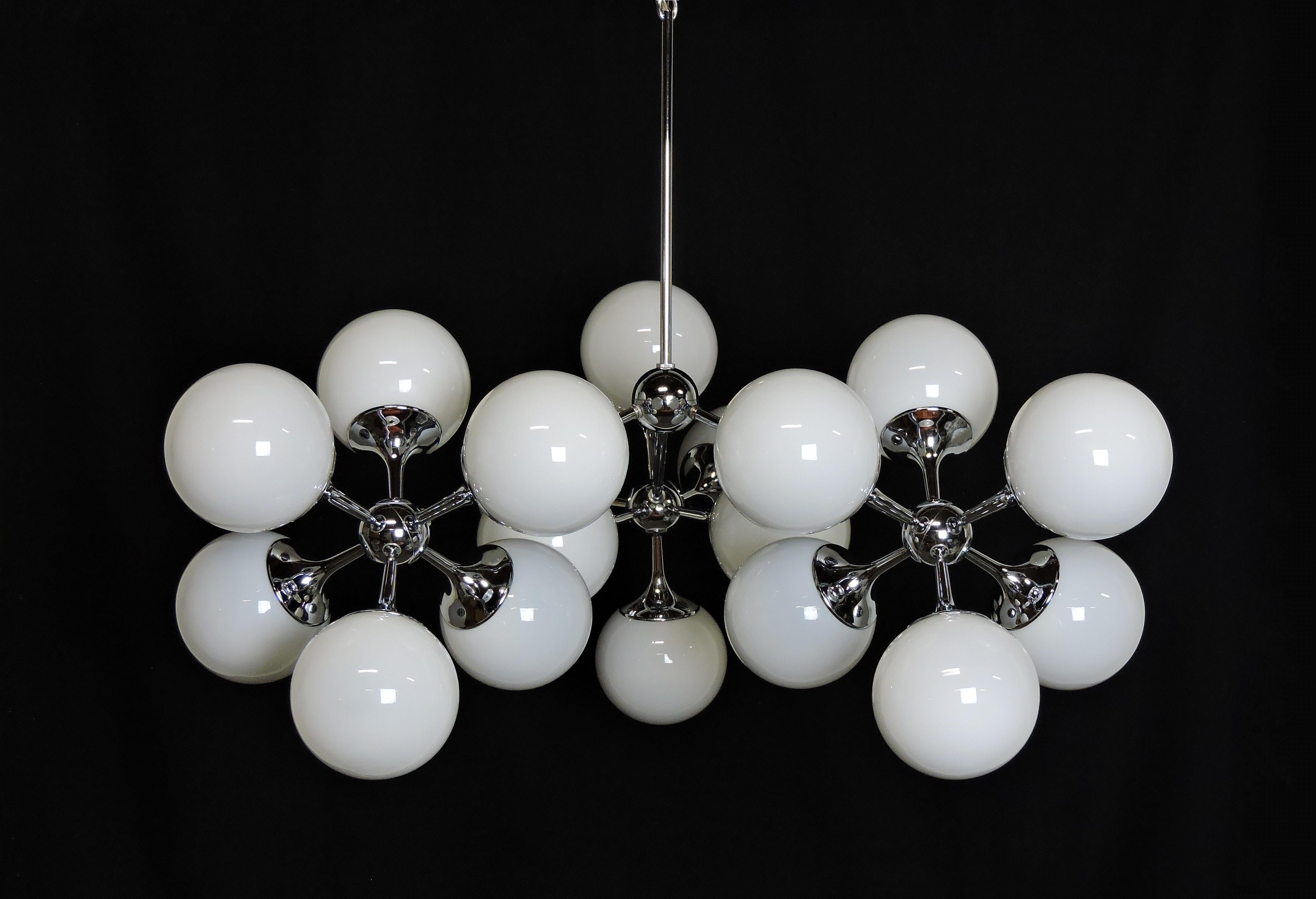 Spectacular Sputnik chandelier by high quality lighting manufacturer, Lightolier. This chrome fixture has three arms radiating out from a central sphere that each end in a 6 light sputnik with hand-blown white glass globes. It has a 13