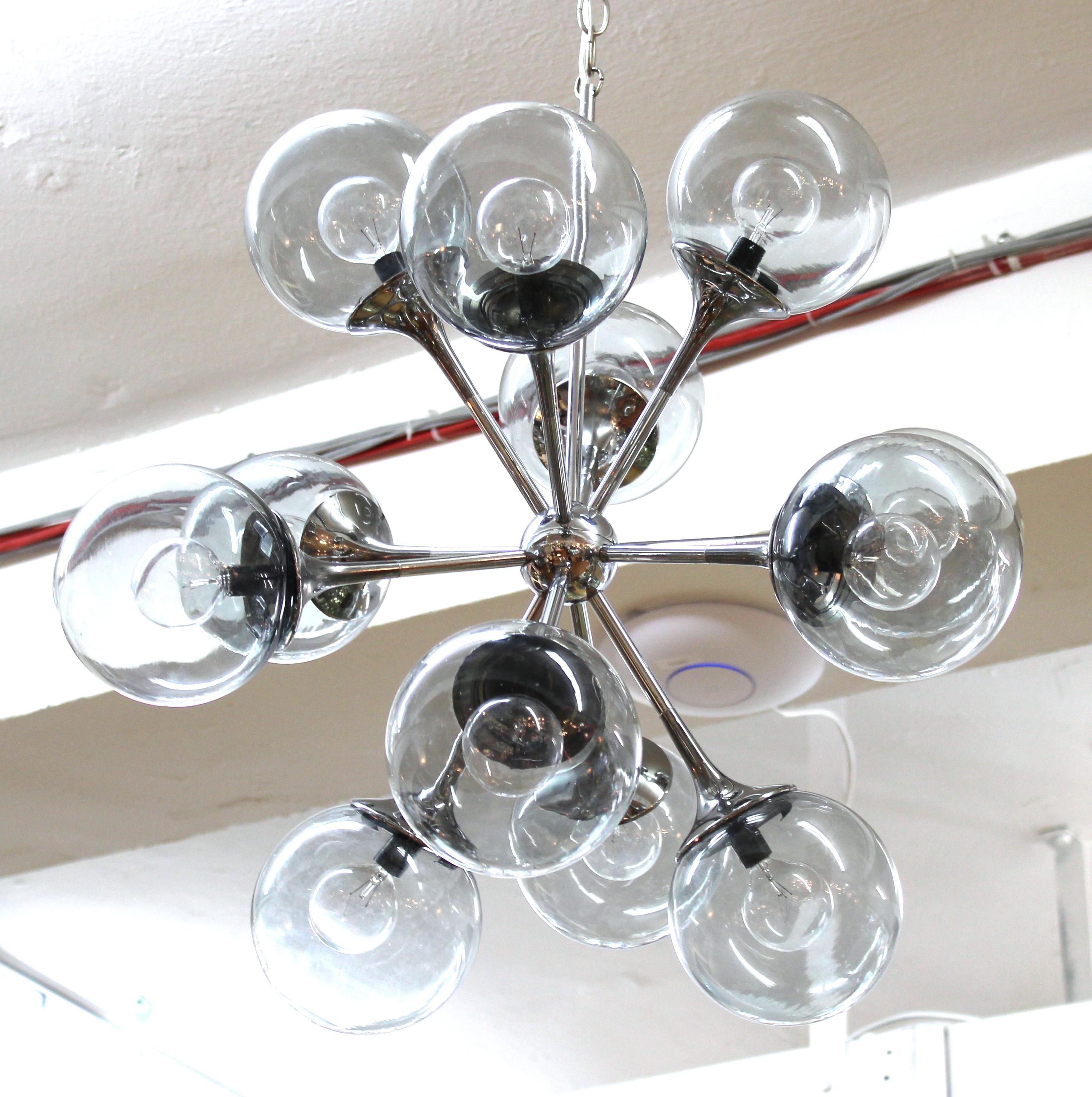 Lightolier American Mid-Century Modern chrome Sputnik Space Age chandelier with glass dome shades, circa 1970's.