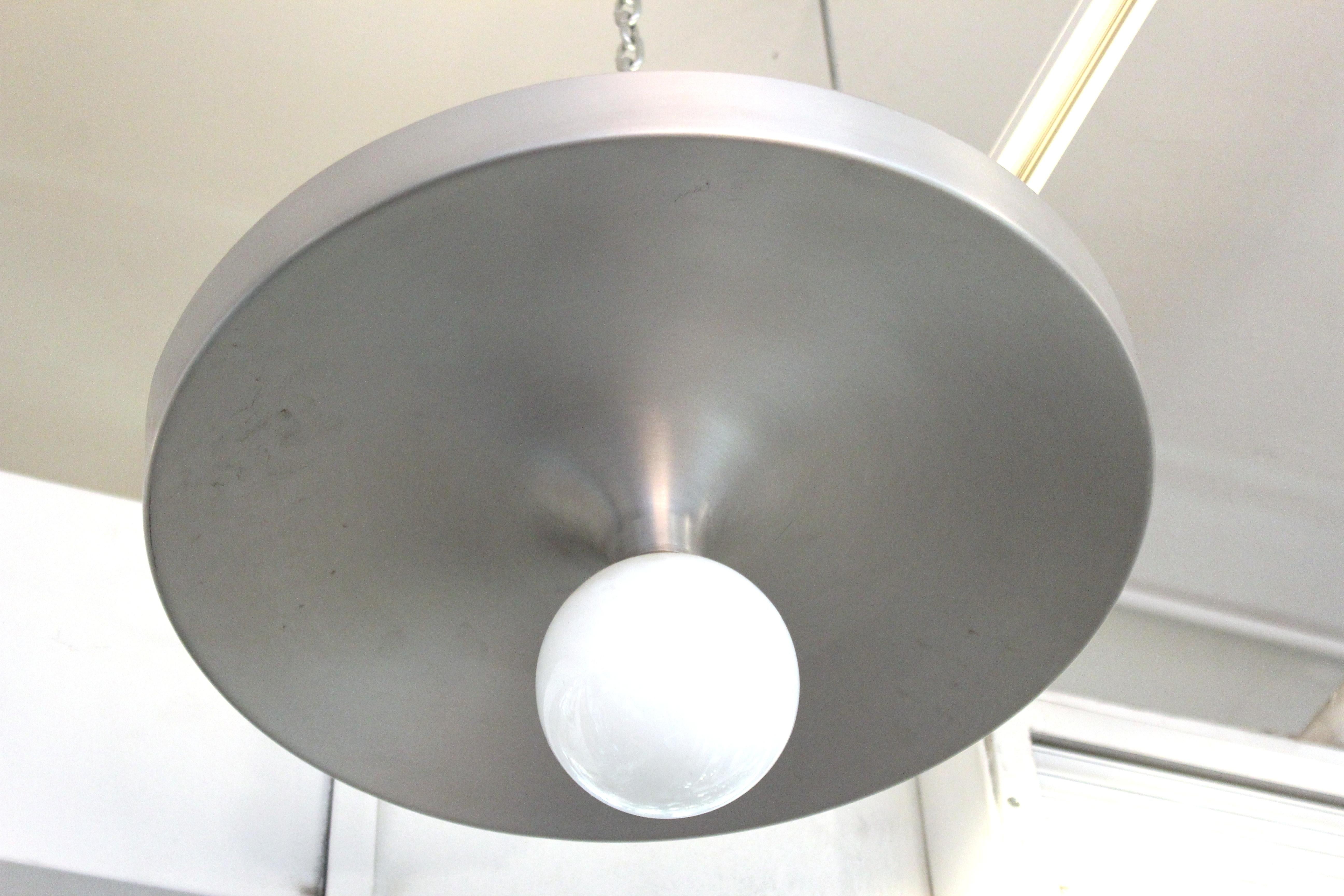 Mid-Century Modern metal saucer flush mount designed by Lightolier. The piece is in great vintage condition with age-appropriate wear and use.