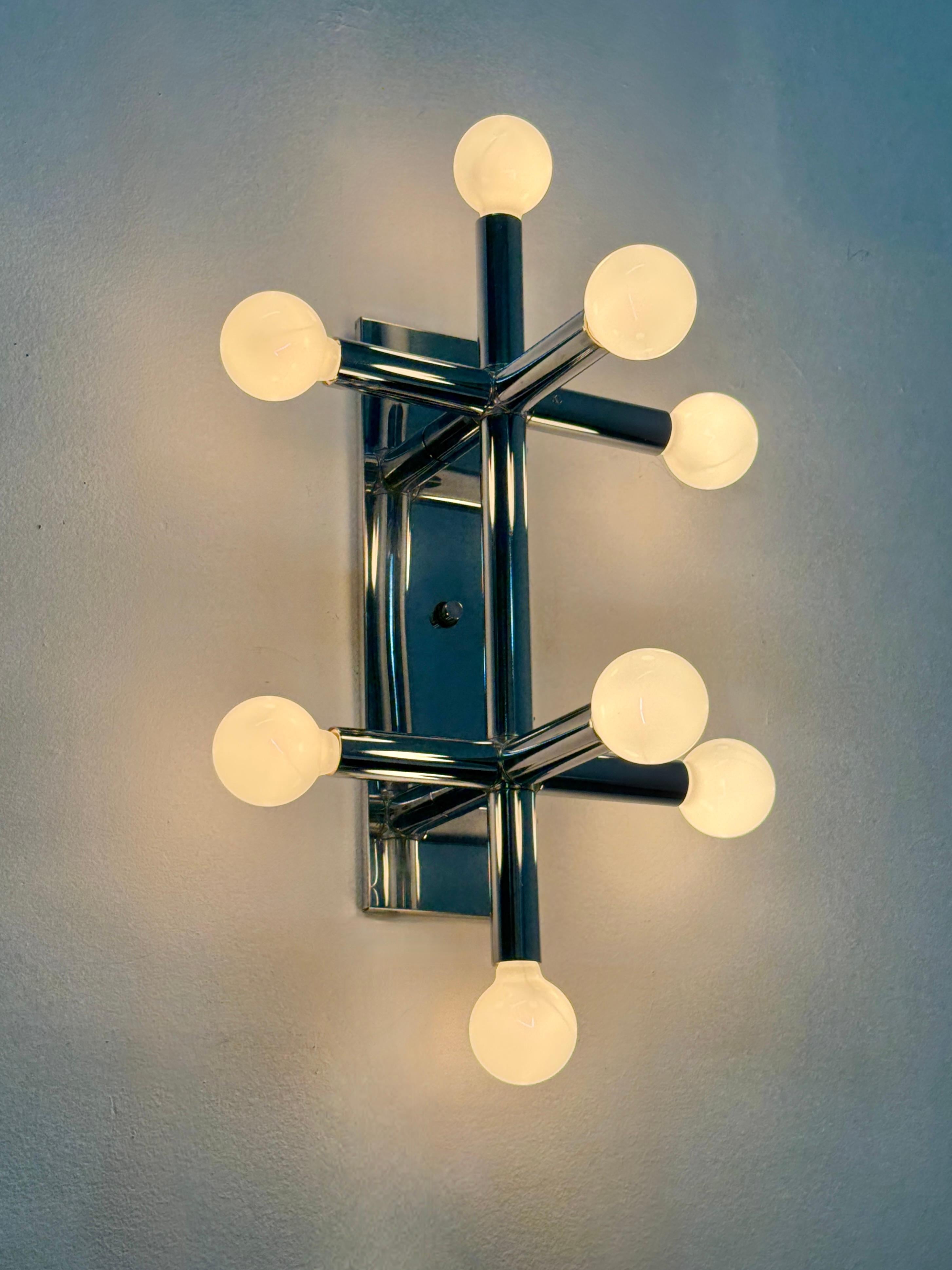 Mid Century space age wall mount sconce or ceiling light by Lightolier West circa 1970s

Flush mount sputnik design of 8 tubular chrome arms with white globe bulbs
Hardwired with original labels intact 

As shown including bulbs:
19 inch width
31