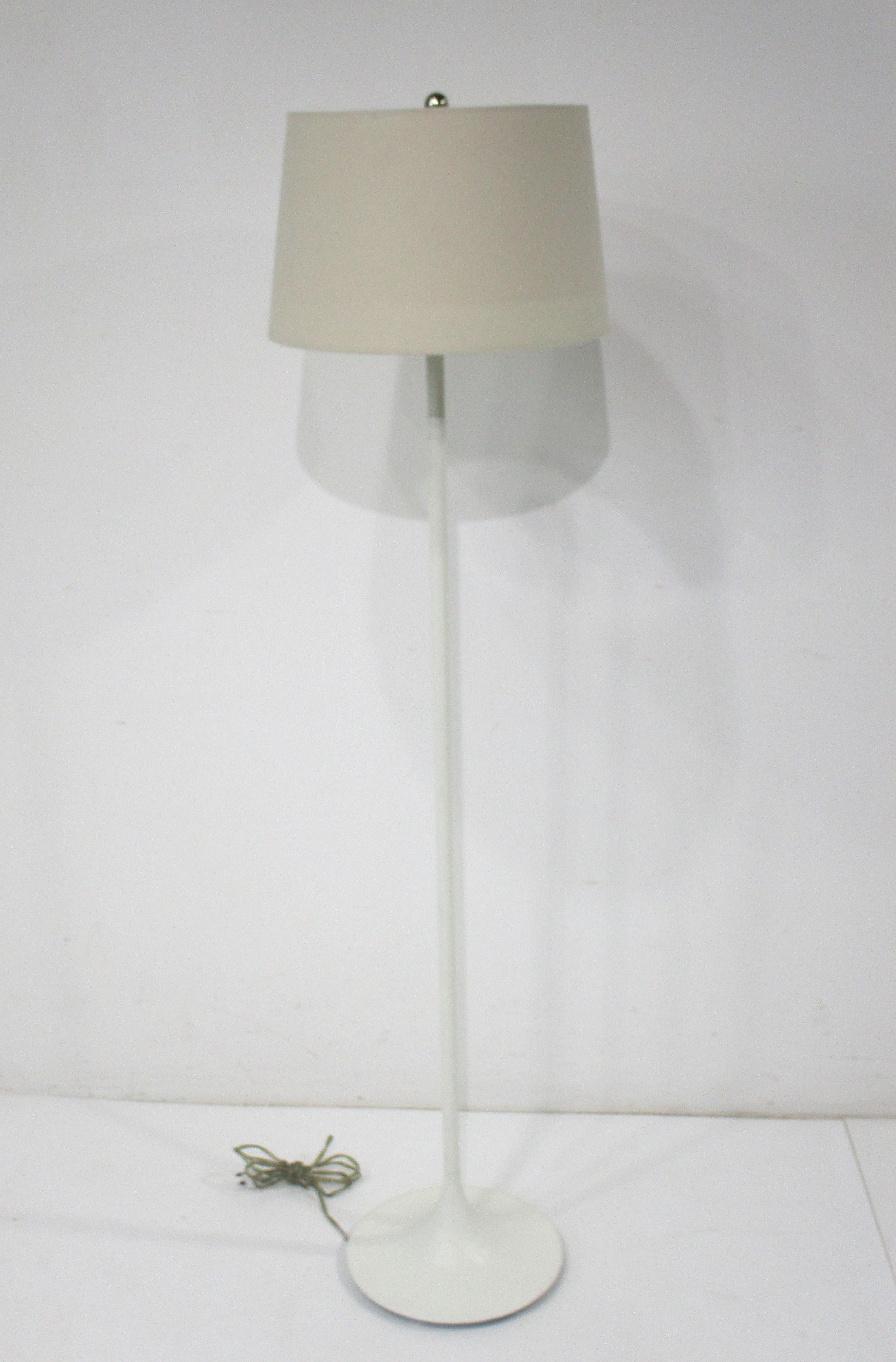 A white tulip styled floor lamp with linen shade in the manner of Eero Saarinen . This hard to find item would go perfectly with your Mid Century Knoll furnishings , nice clean lines and a simple modern look that's fresh today as it was 50 years ago