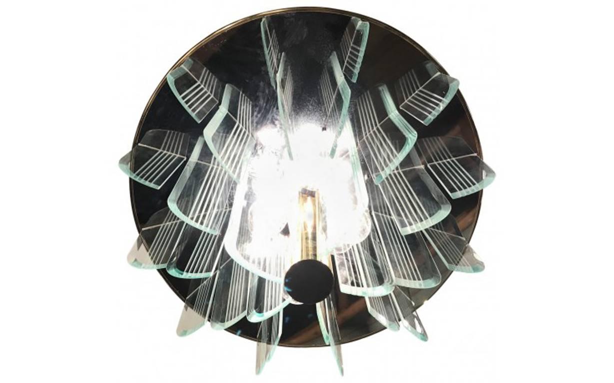 This large and modern chandelier is reminiscent of an opulent Art Deco style. With twelve lights, this imposing fixture is made with etched glass plates for an extraordinary effect.