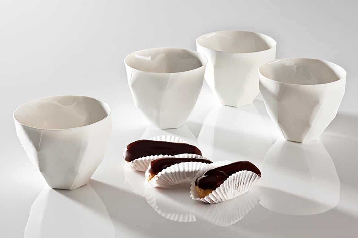We are offering a set of 4 porcelain coffee beaker in Nymphenburg porcelain designed by Ruth Gurvich. The porcelain has the texture of a rough watercolor paper and is exquisite. They are dishwasher safe and bear the mark of Nymphenburg and Ruth