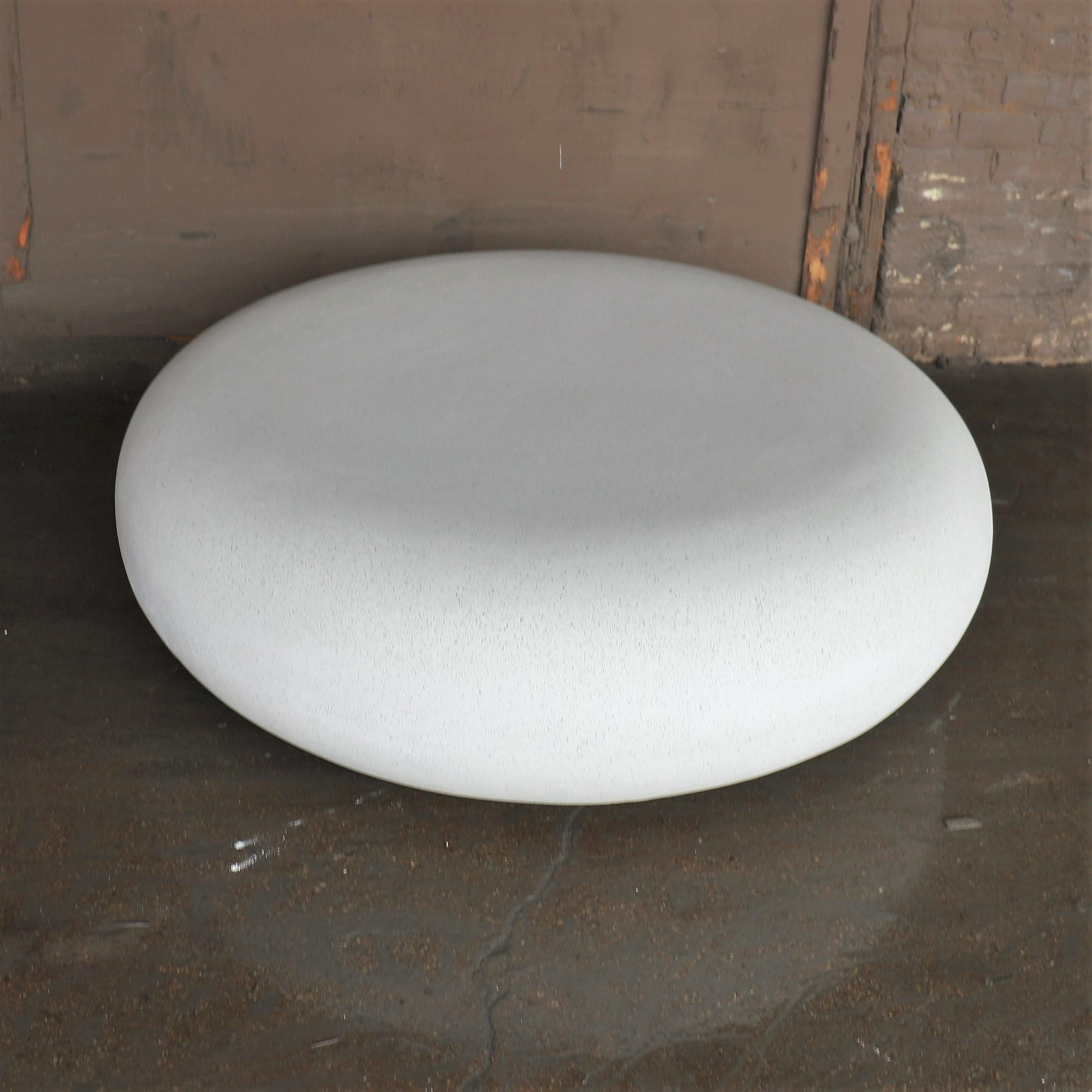Like a stone from a stream, smoothed for millennia by the passing currents. The fluid potential of natural power emanates from its presence.

Dimensions: Diameter 48 in. (122 cm). Height 15 in. (38 cm). Weight 70 lbs. (32 kg).

Finish color