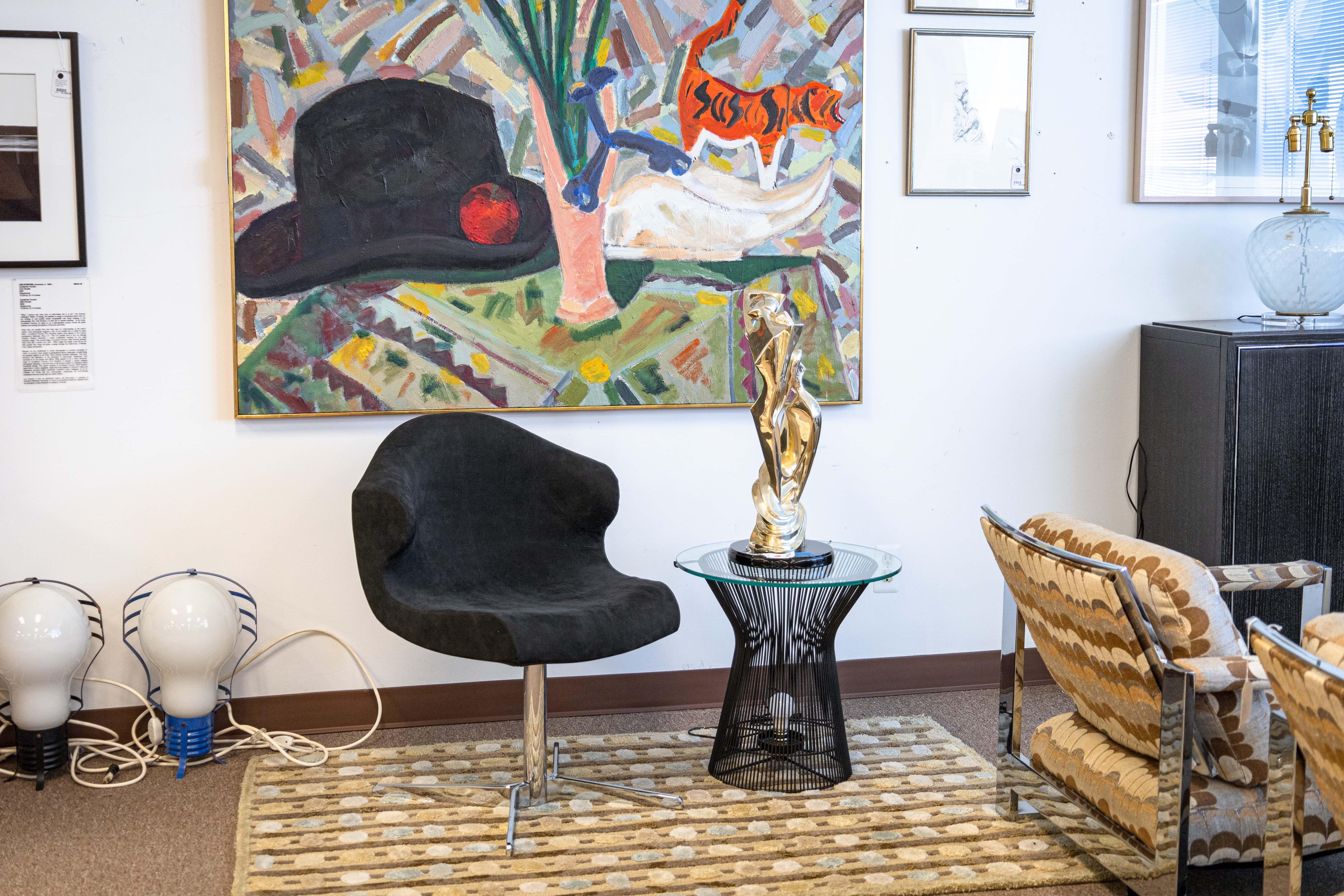 A Ligne Roset Alster armchair. This beautiful accent chair is designed by Emmanuel Dietrich for Ligne Roset. This piece features a tubular chrome steel pedestal frame with four angular X-shaped feet. The upper features a black slate alcantara