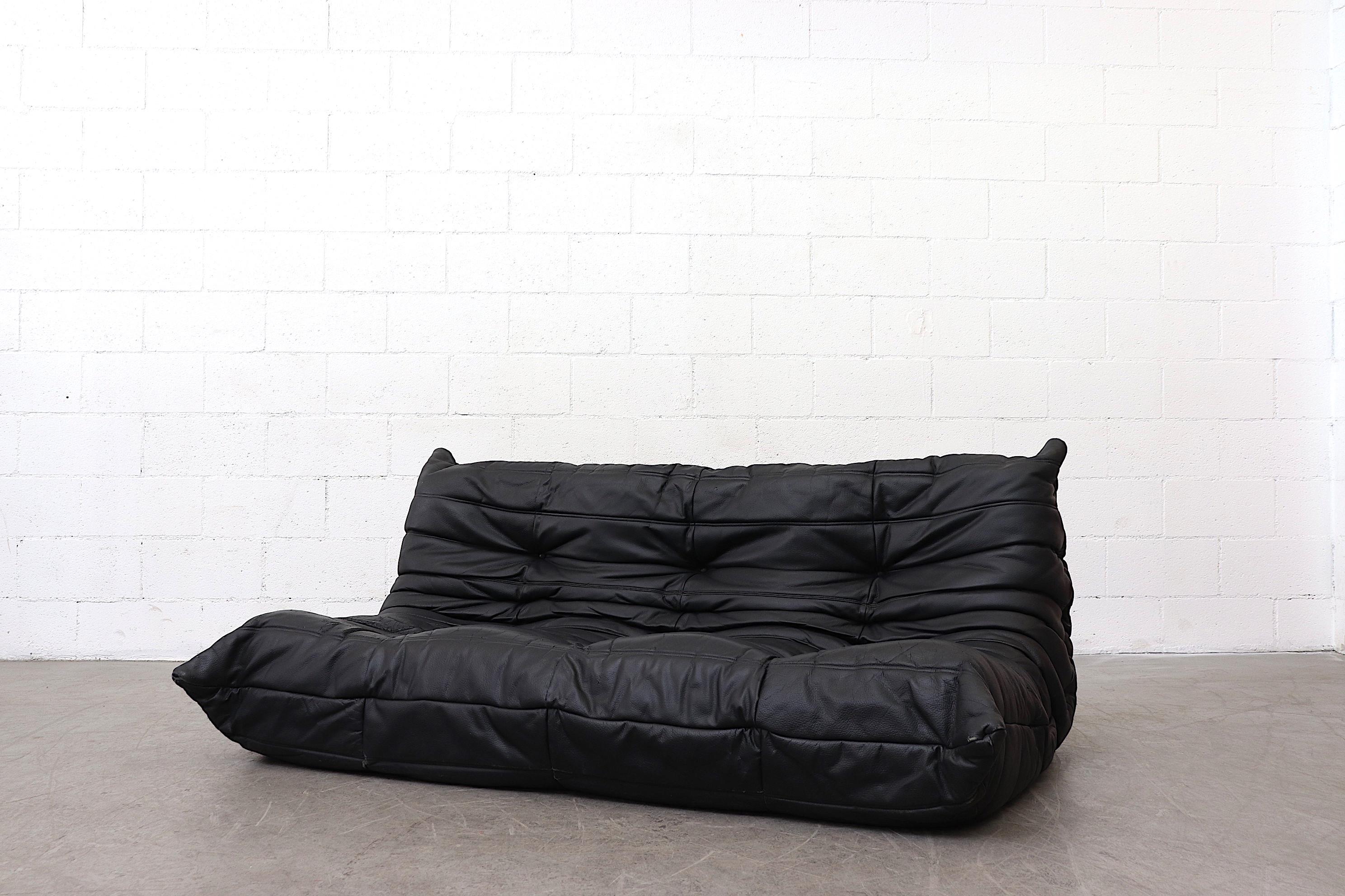 Ligne Roset black leather 'TOGO' sofa. Heavy patina. In very original condition with visible signs of wear, including a small rip to leather on top of backrest of sofa 'A' and visible cracking. The other sofa ('B') is SOLD. Detail photos shown here
