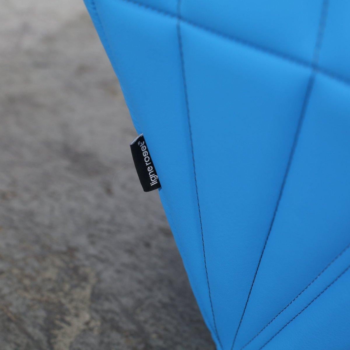 Introducing the Ligne Roset Blue Facett Armchair, designed by renowned duo R. & E. Bouroullec. This stunning piece is a true statement of luxury and style, featuring a unique faceted design and a vibrant blue colour that would add a pop of colour to