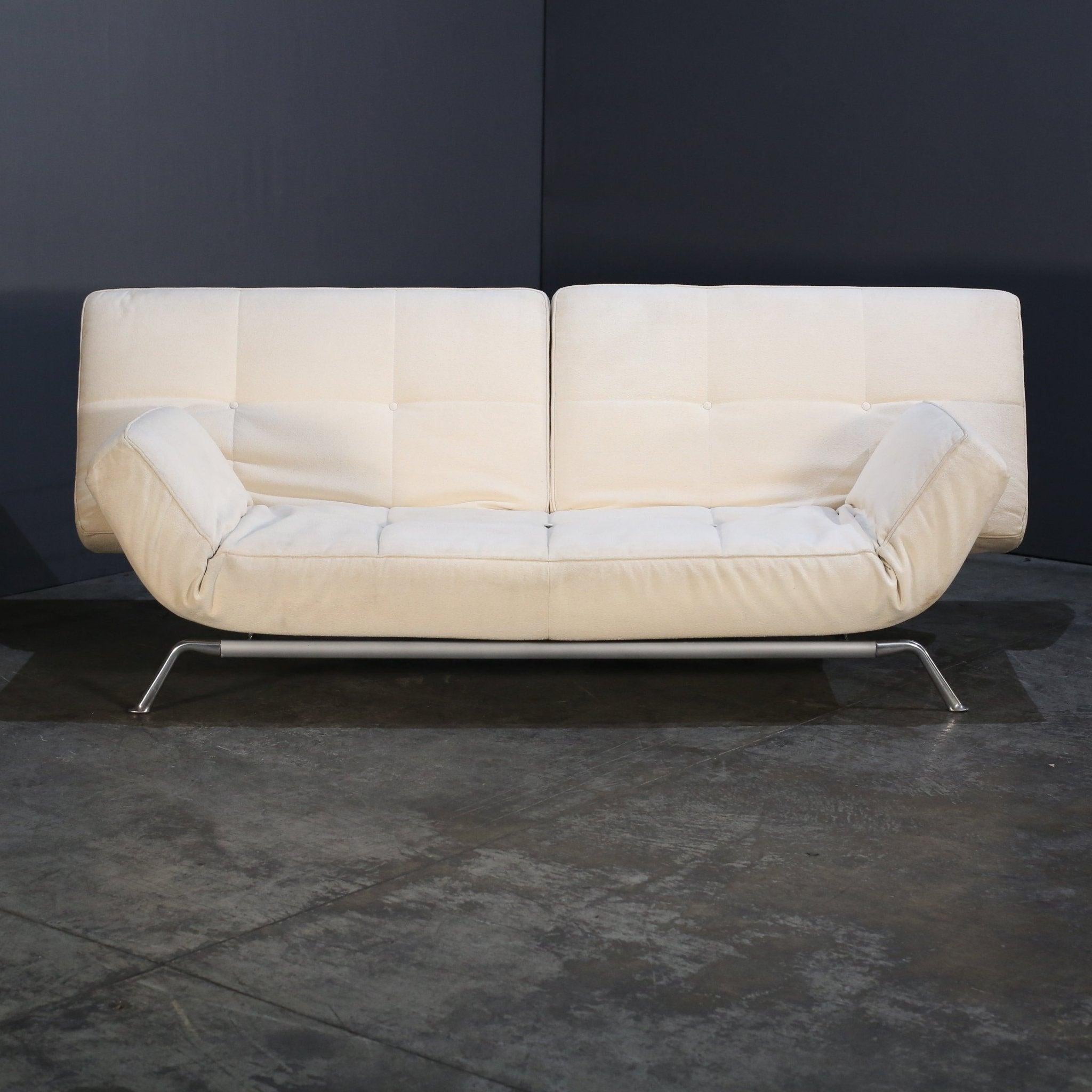 The Ligne Roset Leather Smala Sofa, designed by Pascal Mourgue, epitomizes modern elegance and comfort. Upholstered in luxurious cream boucle fabric, its sleek lines and minimalist aesthetic create a stunning focal point in any living space. The