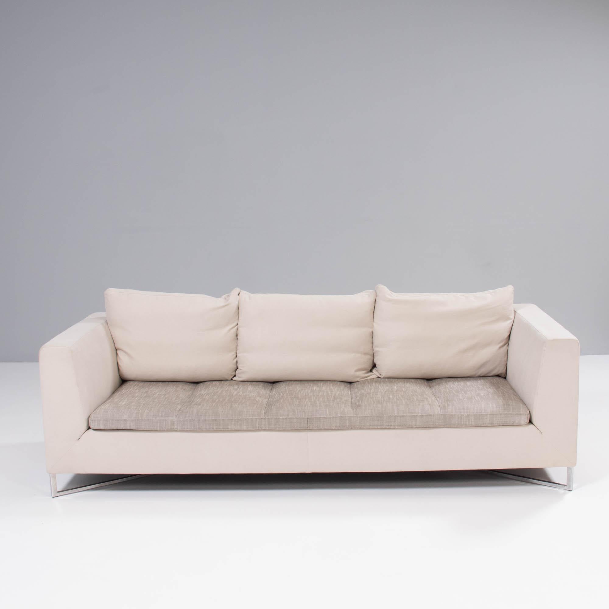 Designed by Didier Gomez for Ligne Roset, this Feng three-seat sofa combines modern elegance with ultimate comfort.

The sturdy frame is upholstered in cream woven fabric and sits on an angular chrome base. 

The cream fabric is contrasted by