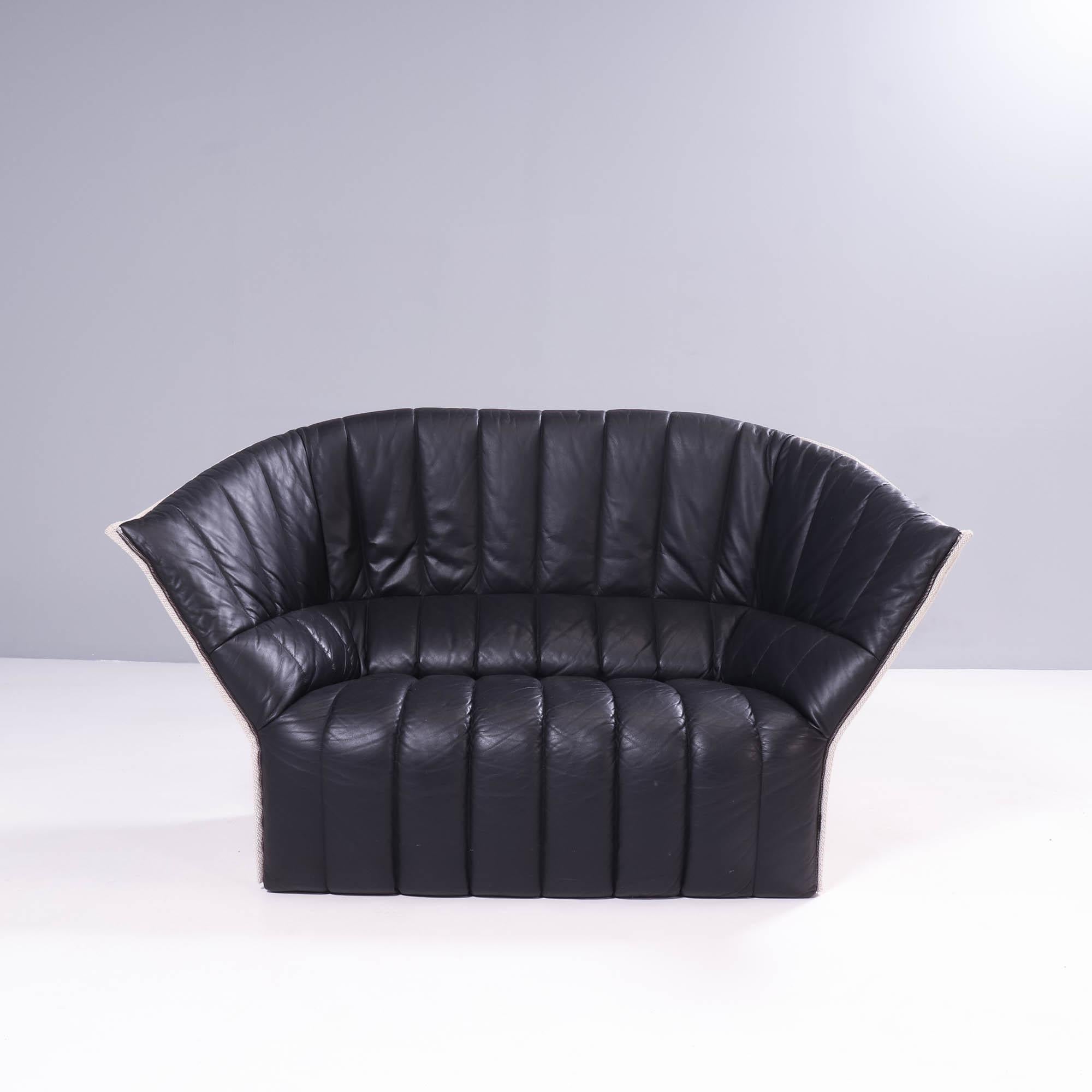 Designed by Inga Sempé for Ligne Roset, the Moel loveseat is a striking piece of contemporary design.

With a shell-like silhouette, the Moel loveseat sofa features a quilted seat front in supple black leather and a contrasting white fabric