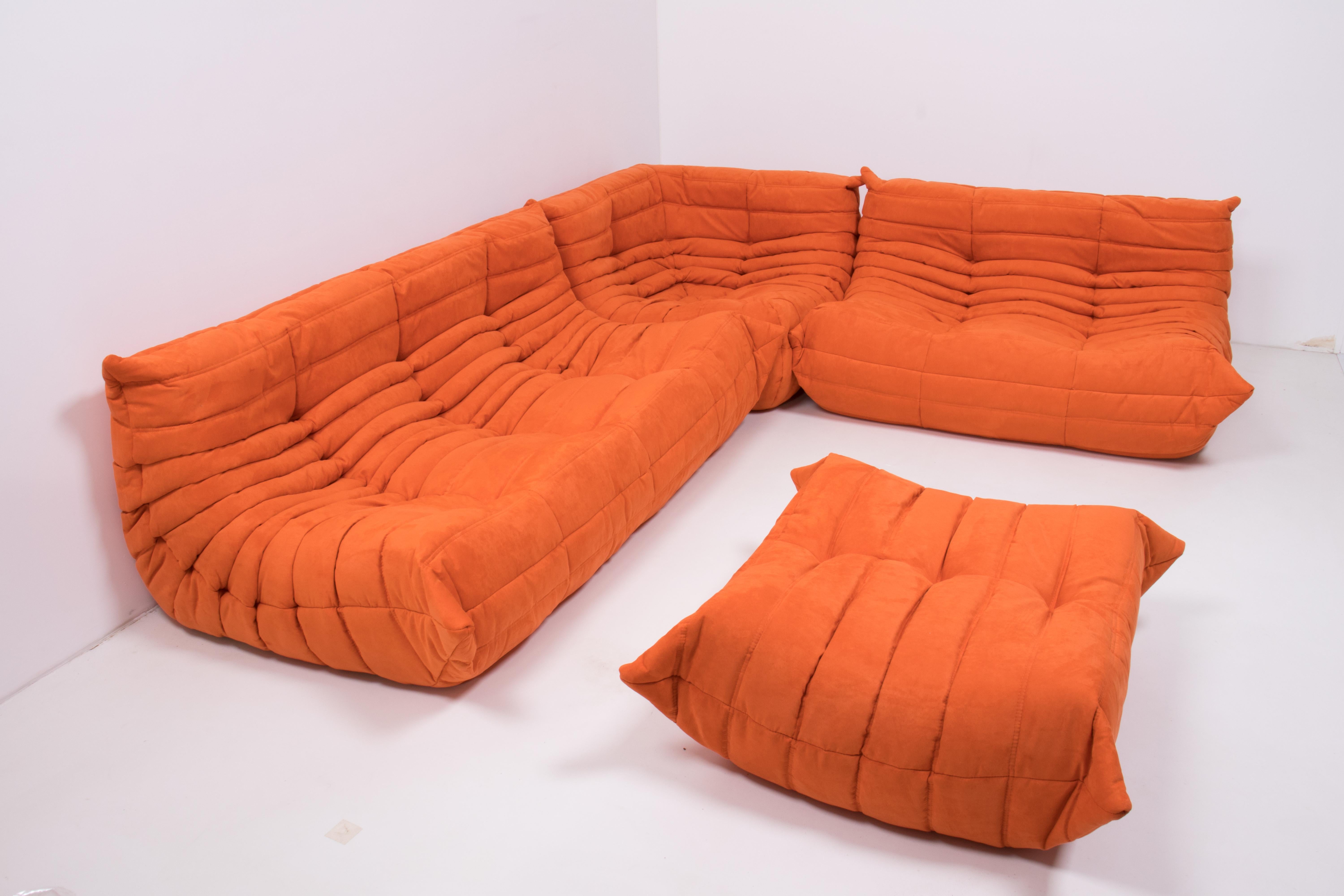 The iconic Togo orange sofa set, originally designed by Michel Ducaroy for Ligne Roset in 1973, has become a design mid century classic.

The sofas have been newly reupholstered in a soft bright orange coloured fabric. Made completely from foam,