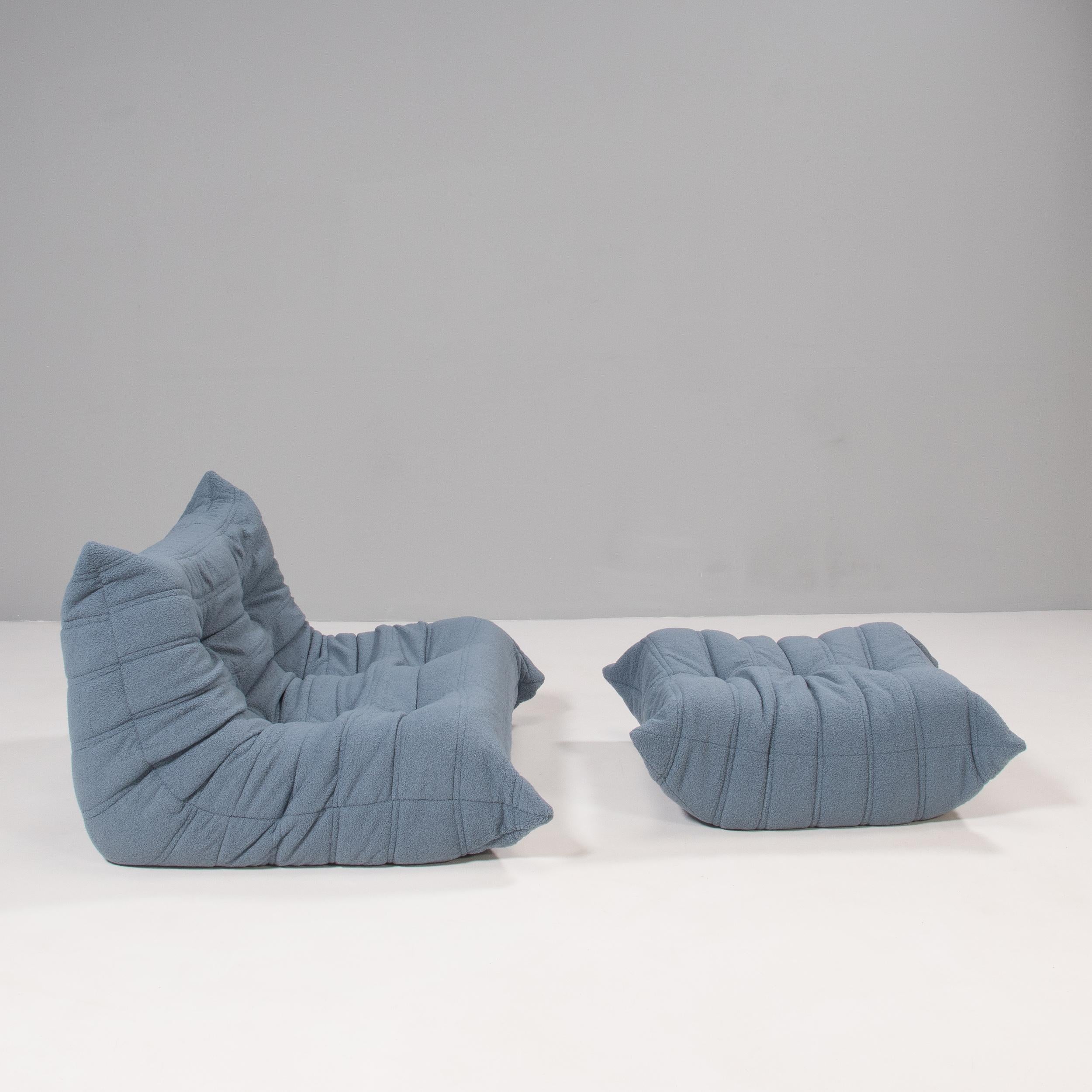 The iconic Togo sofa, originally designed by Michel Ducaroy for Ligne Roset in 1973, has become a design classic. 

These 2-seat model and footstool have been newly reupholstered in extra soft blue bouclé fabric and features the instantly