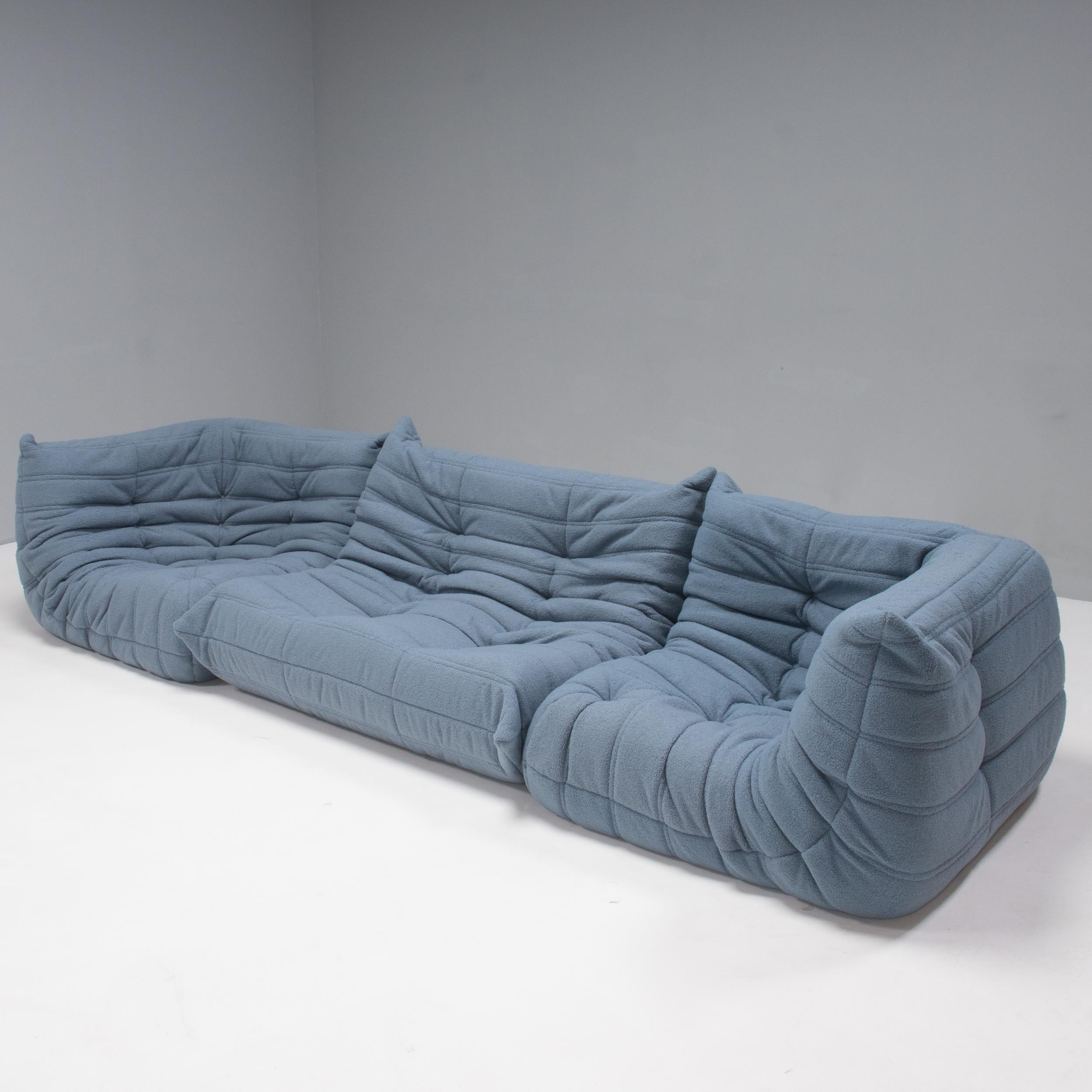 The iconic Togo sofa, originally designed by Michel Ducaroy for Ligne Roset in 1973, has become a design classic. 

These 2-seater sofa and two corners have been newly reupholstered in extra soft blue bouclé fabric and features the instantly