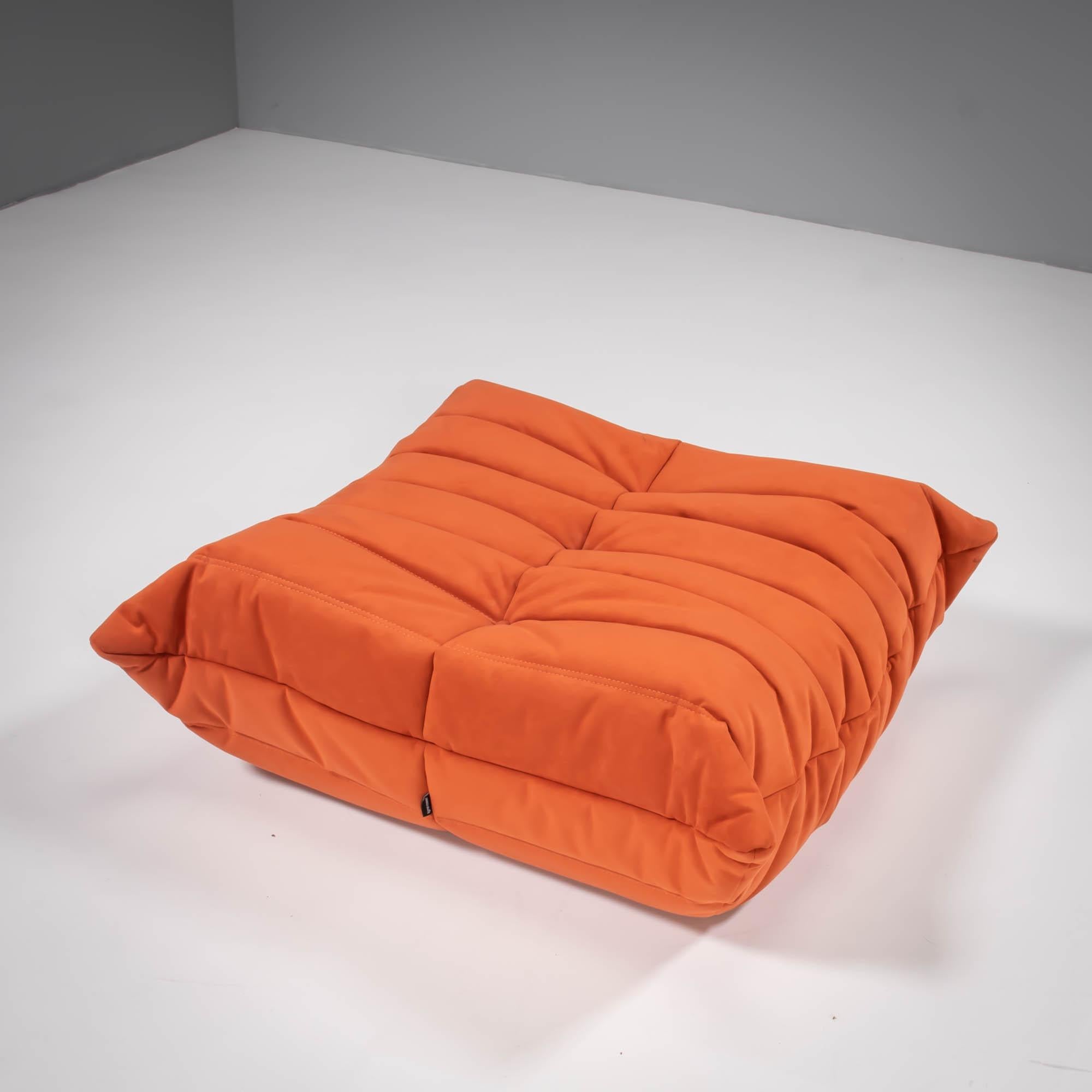 The iconic Togo sofa, originally designed by Michel Ducaroy for Ligne Roset in 1973 has become a design Classic.

The footstool features cadmium orange upholstery and the instantly recognizable pleated fabric design, which gives the sofa its relaxed