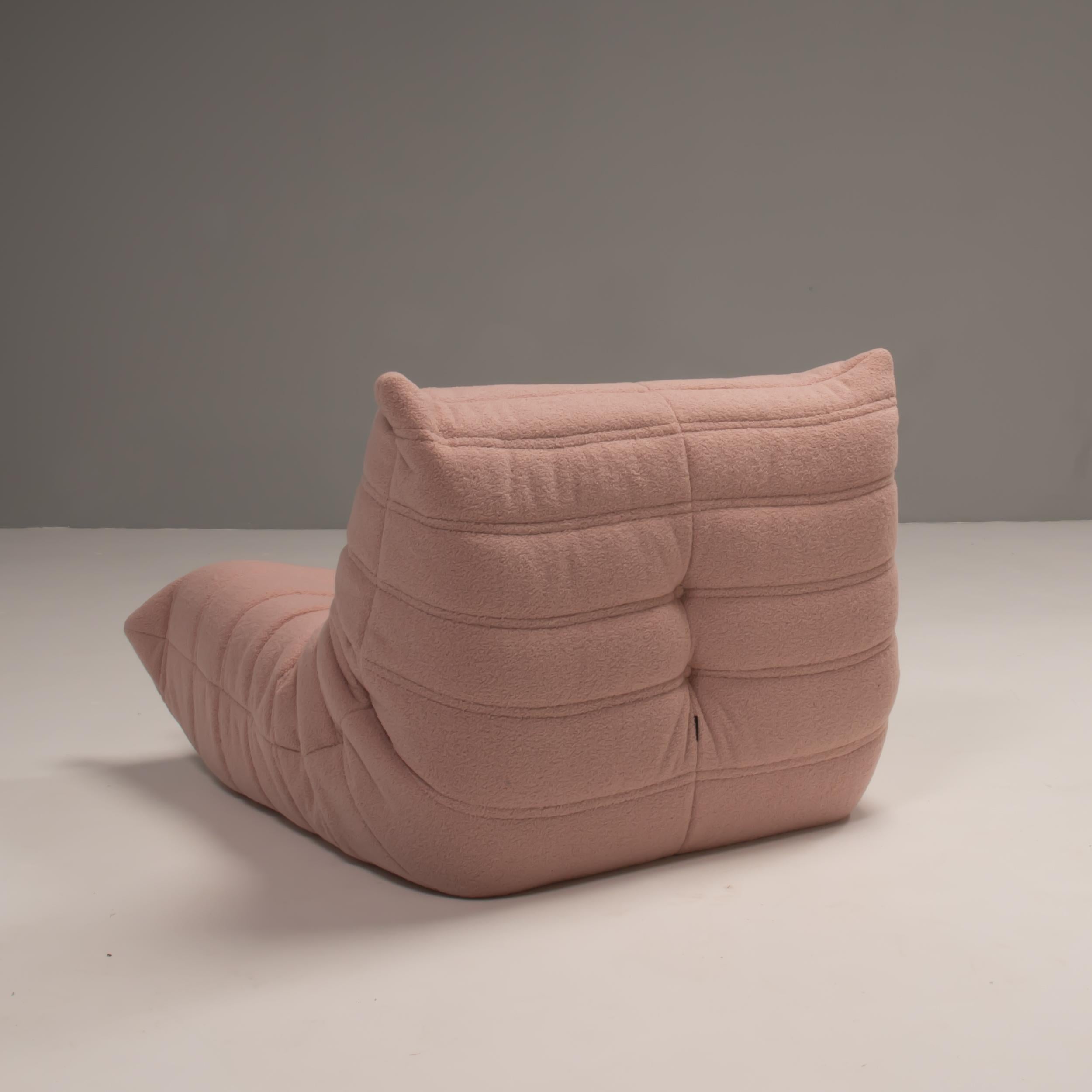 The iconic Togo sofa, originally designed by Michel Ducaroy for Ligne Roset in 1973, has become a design classic. 

This armchair has been reupholstered in light candy floss pink bouclé fabric and features the instantly recognisable pleated fabric