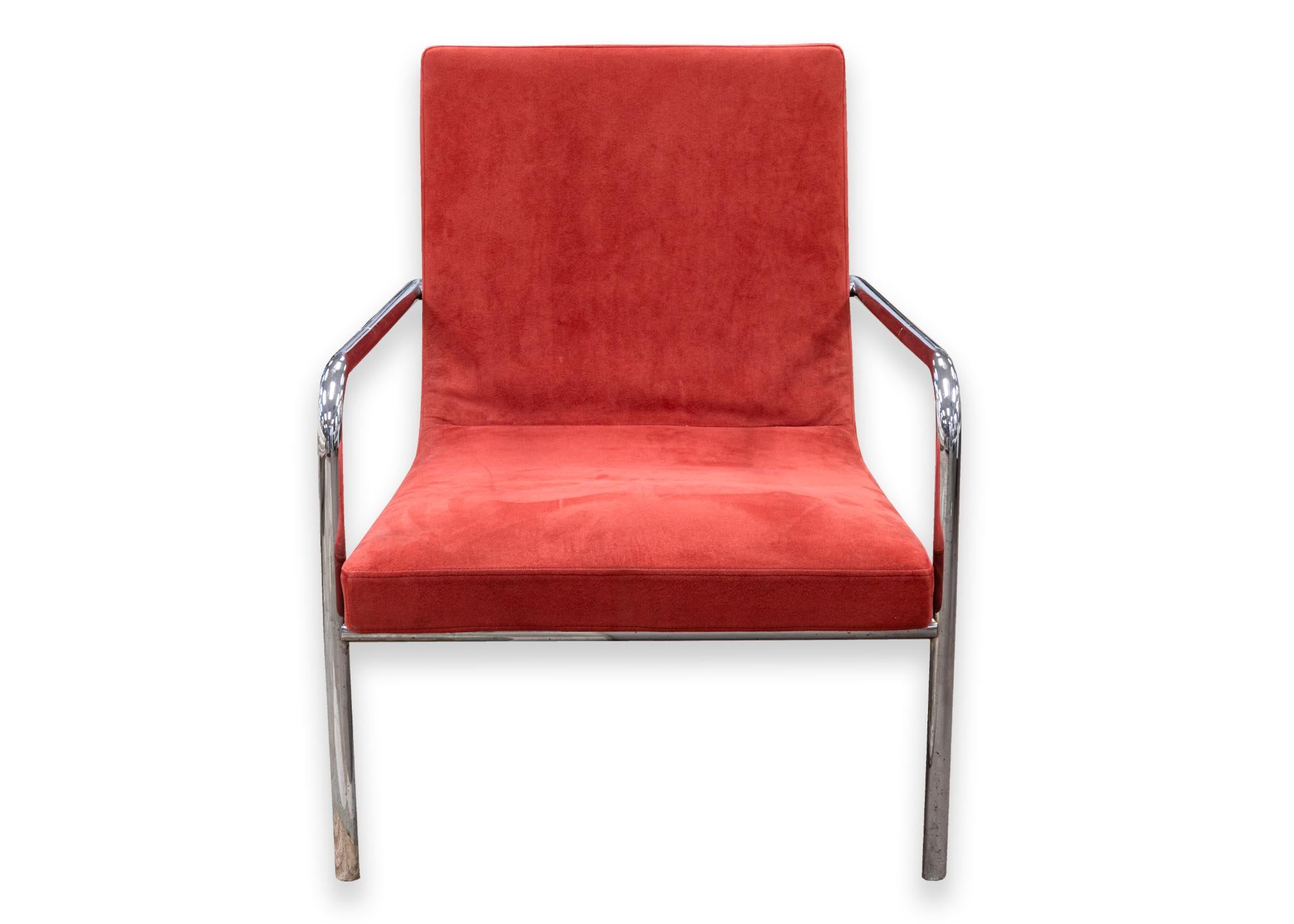 A Ligne Roset Dessau lounge chair. A gorgeous contemporary accent chair. This piece features a tubular chrome frame, arms and legs, and a super chic soft red suede leather upholstery. This piece is in very good condition. The original Ligne Roset