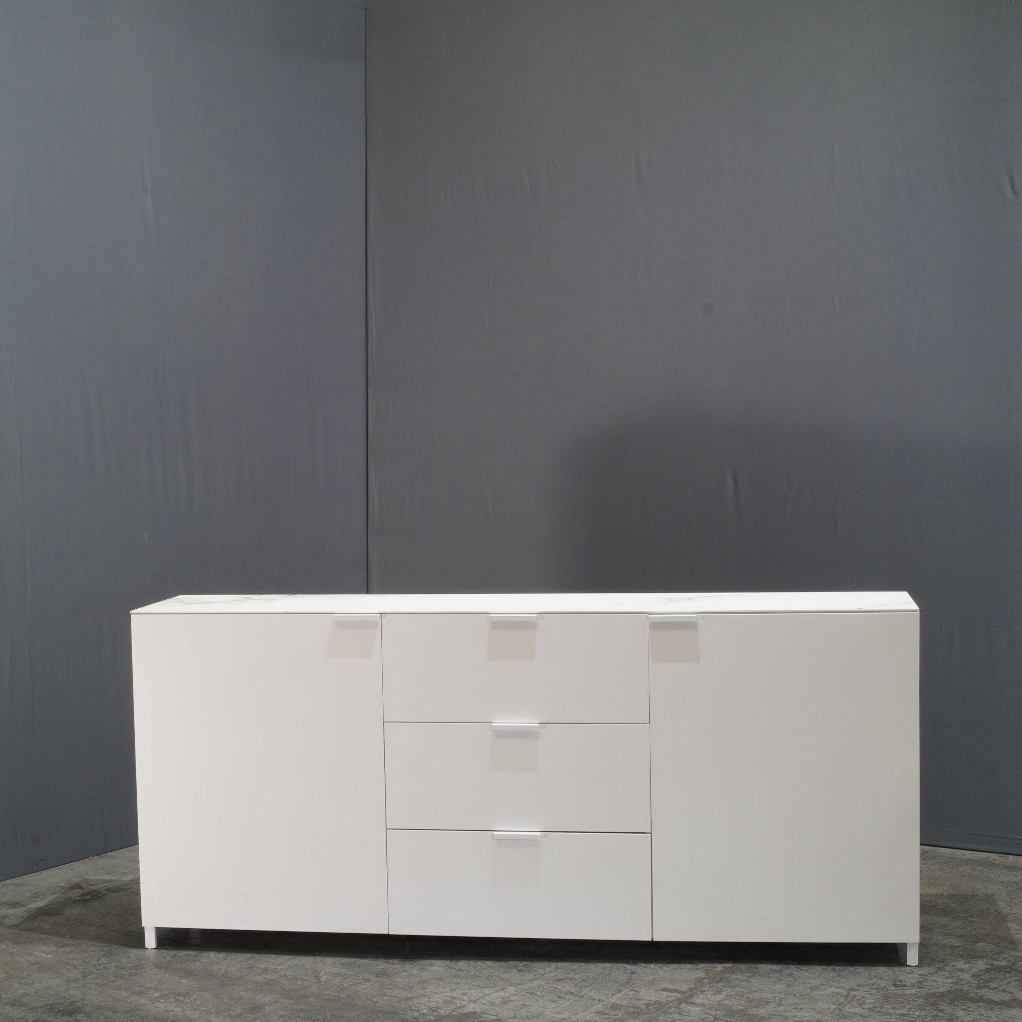 Discover refined elegance with the Ligne Roset Everywhere C4 Sideboard, designed by Christian Werner. This sophisticated piece features a sleek, streamlined silhouette with a combination of two doors and three drawers, offering ample storage while