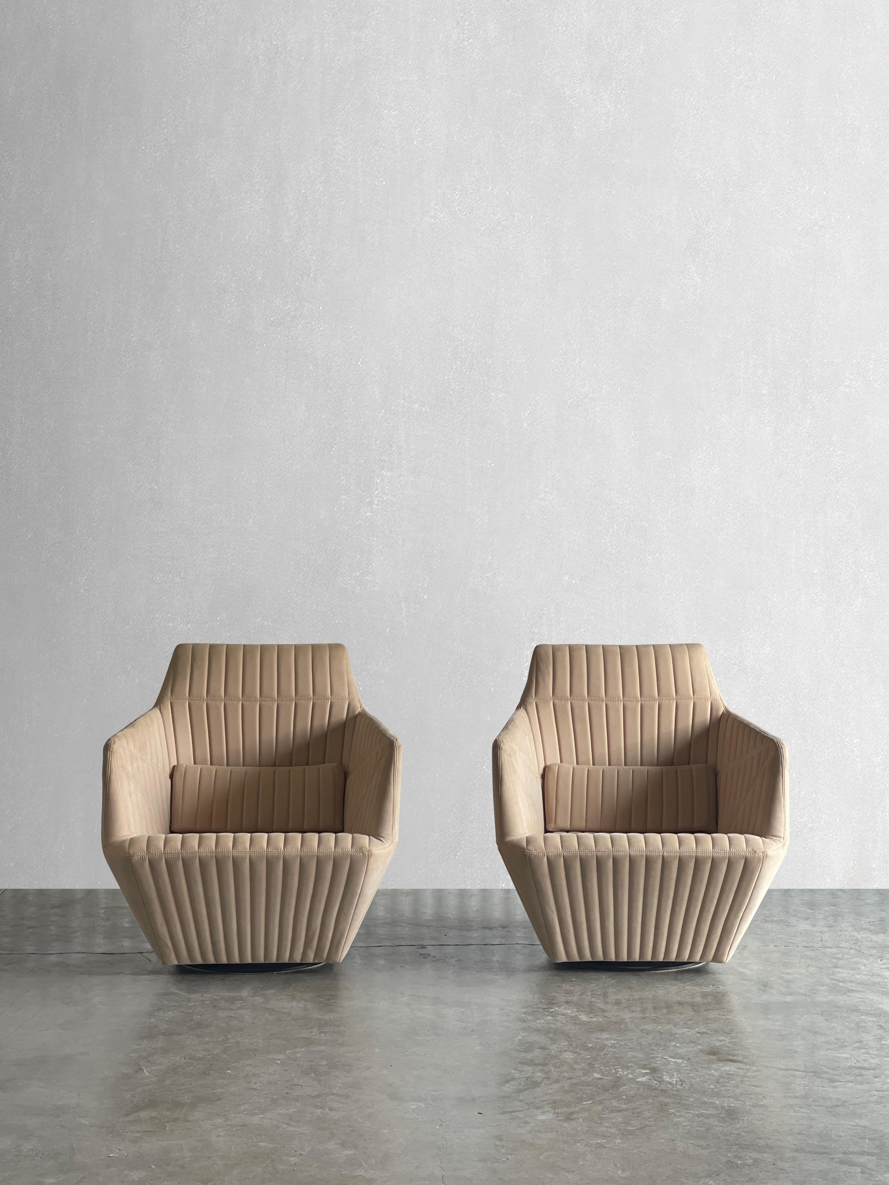 A pair of truly unique statement chairs. The stitching on the Facet chairs resembles the shape of a gemstone or origami. these chairs are upholstered in original stone colored alcantara fabric, which is in excellent condition. 


Dimensions:

33H x