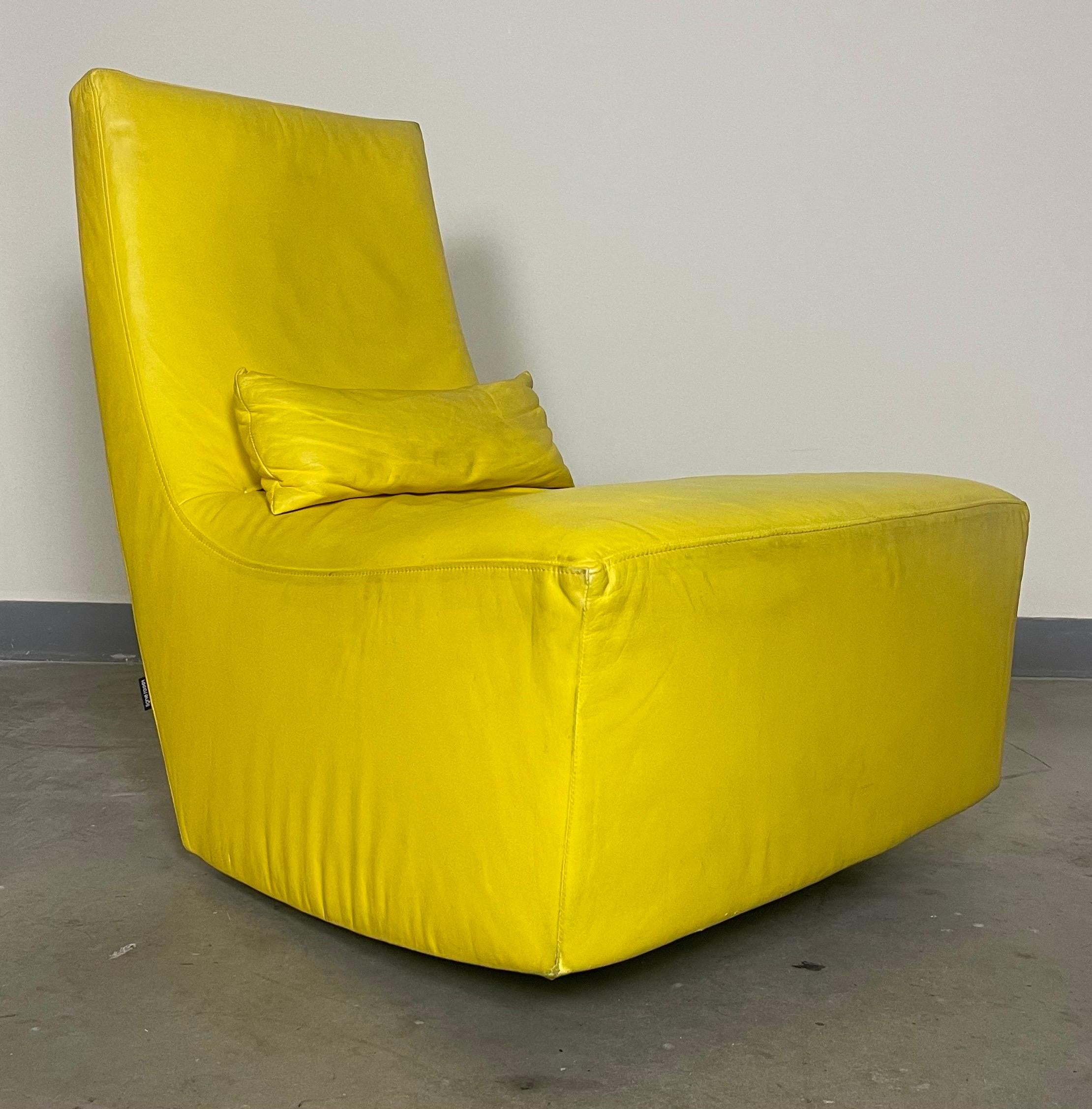 Ligne Roset Fireside “Neo” Rocker in yellow leather with a lumbar pillow. Imperfections, dents, and wear to the leather. Good candidate for reupholstery.