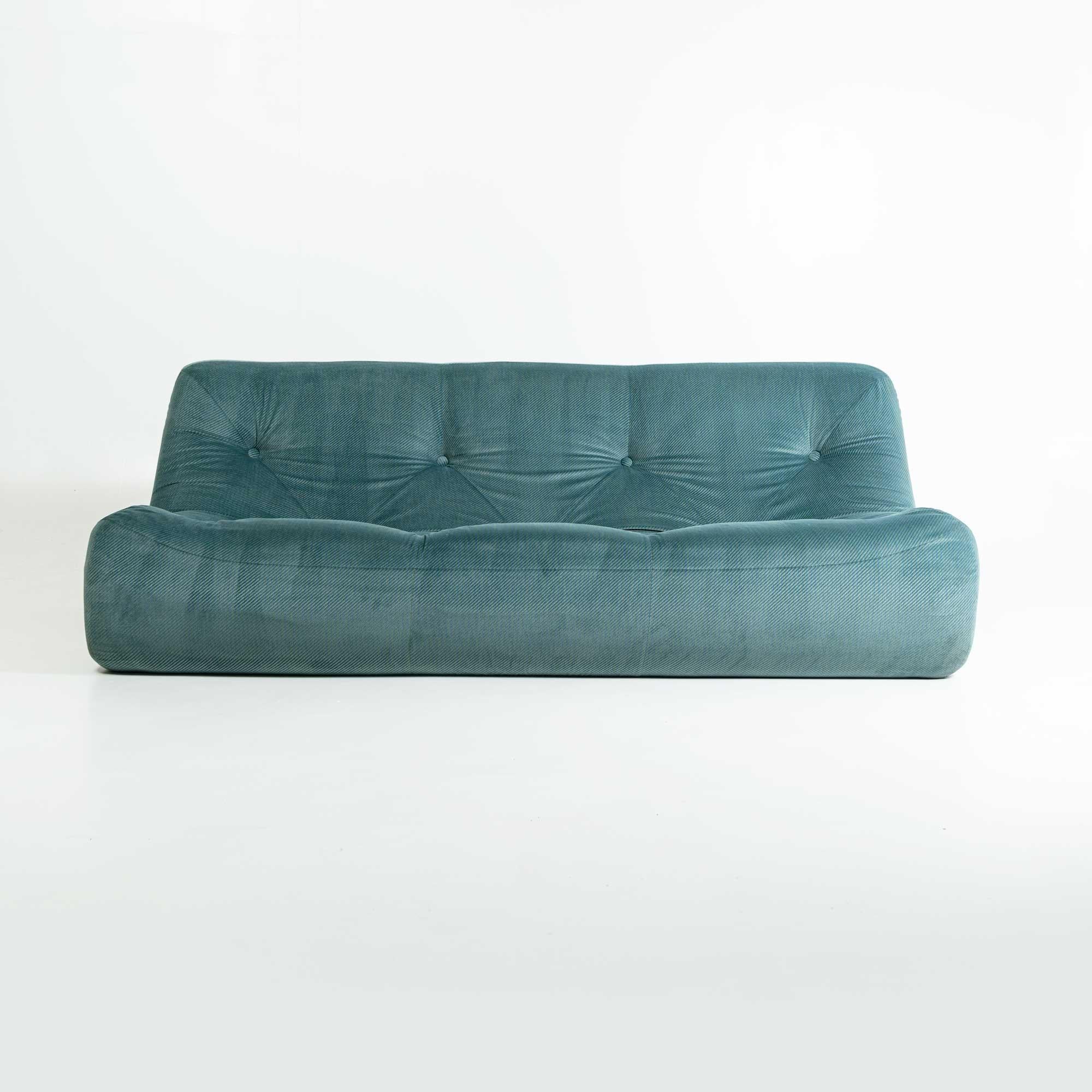 This is the Kali three seater sofa designed by Michel Ducaroy for Ligne Roset, France, upholstered in original Emerald Corduroy with blue stitching. A very unique fabric, soft and in good condition. Ready to be used.

The 'Kali' sofa by Michel