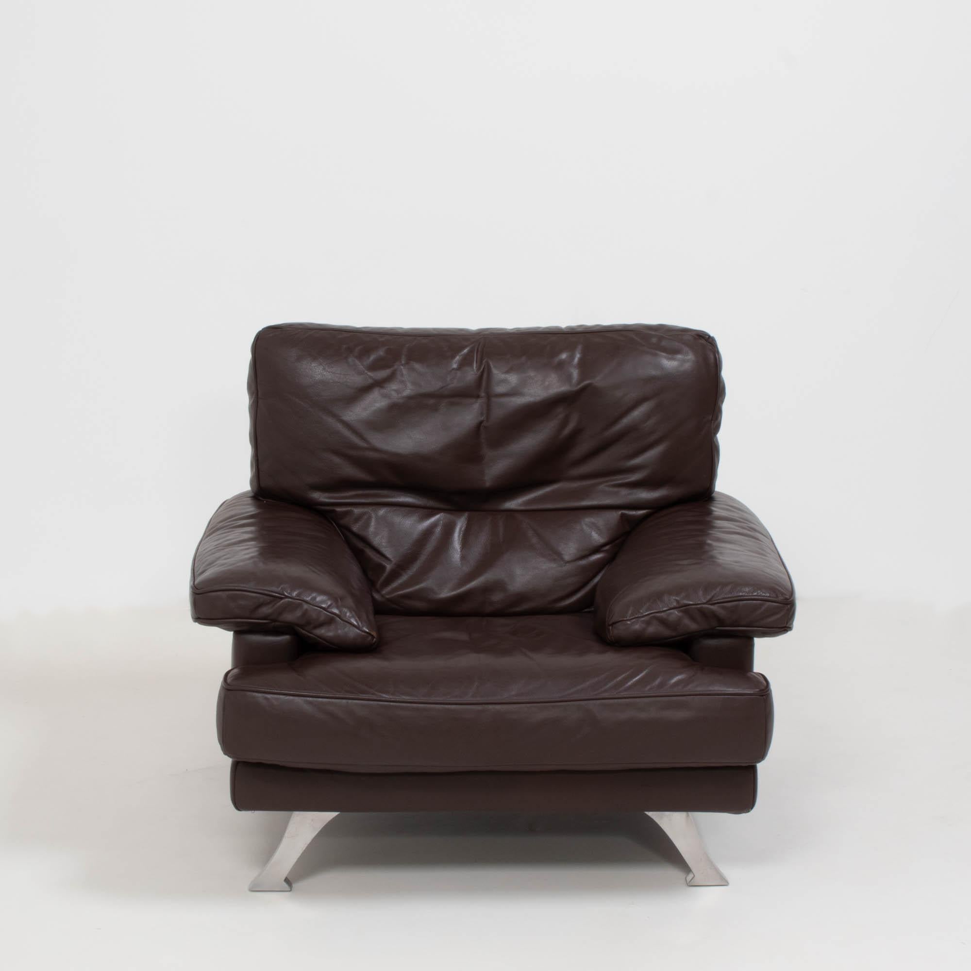 Manufactured by Ligne Roset, this Melodie armchair gives the traditional design a modern twist.

Upholstered in buttery dark brown leather, the seat offers ultimate comfort with deep back and seat cushions and additional padding over the