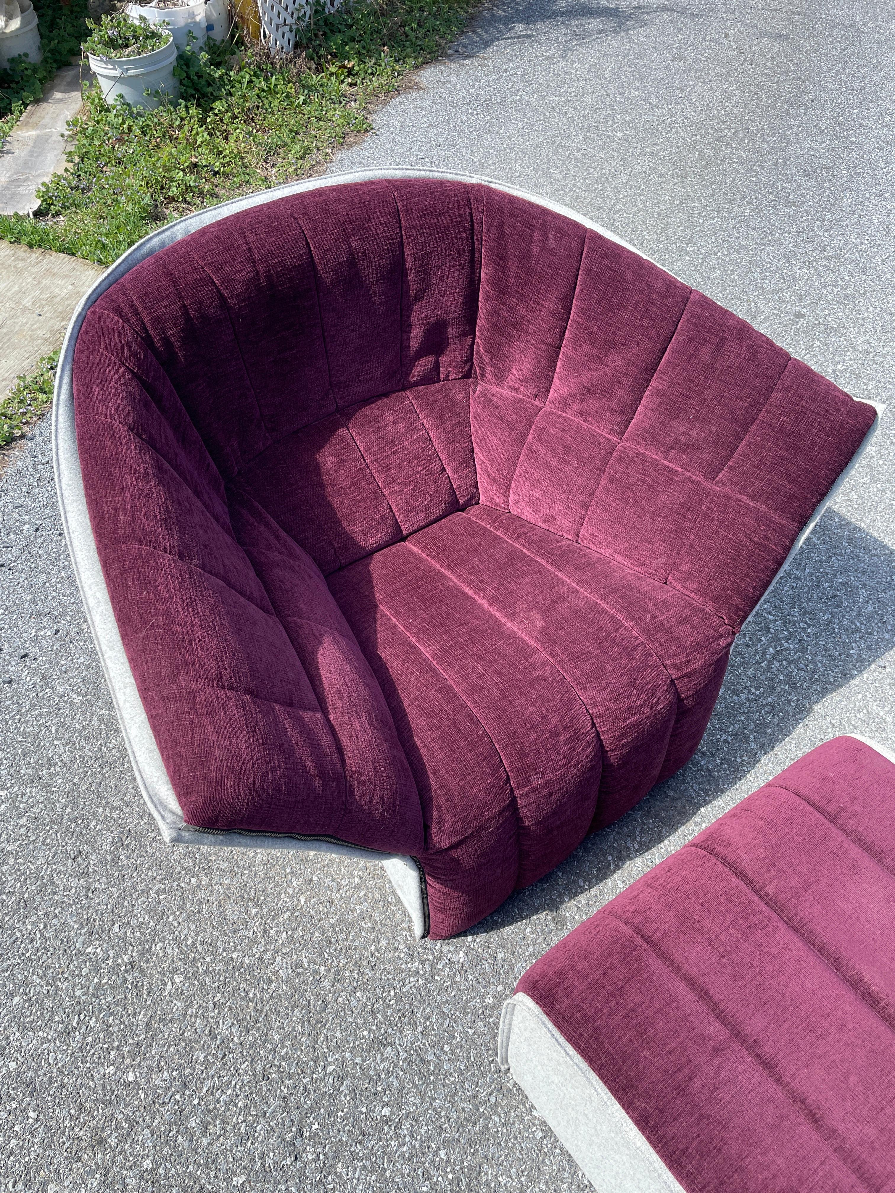 A gorgeous and super comfy chair and ottoman by Inga Sempé for Ligne Roset. The set has lush burgundy upholstery and a grey felt shell making it soft to the touch over every square inch. The upholstery zips off for easy cleaning and Ligne Roset