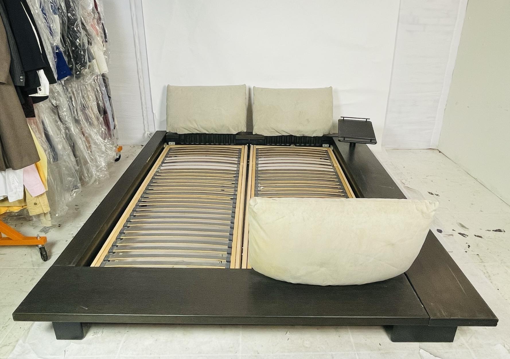 This is the original iconic platform bed created by German designer Peter Maly for Ligne Roset, purchased in San Francisco in 1998. It is a European queen size, and the frame is made of a beautiful dark laminated wood in an asymmetrical design with