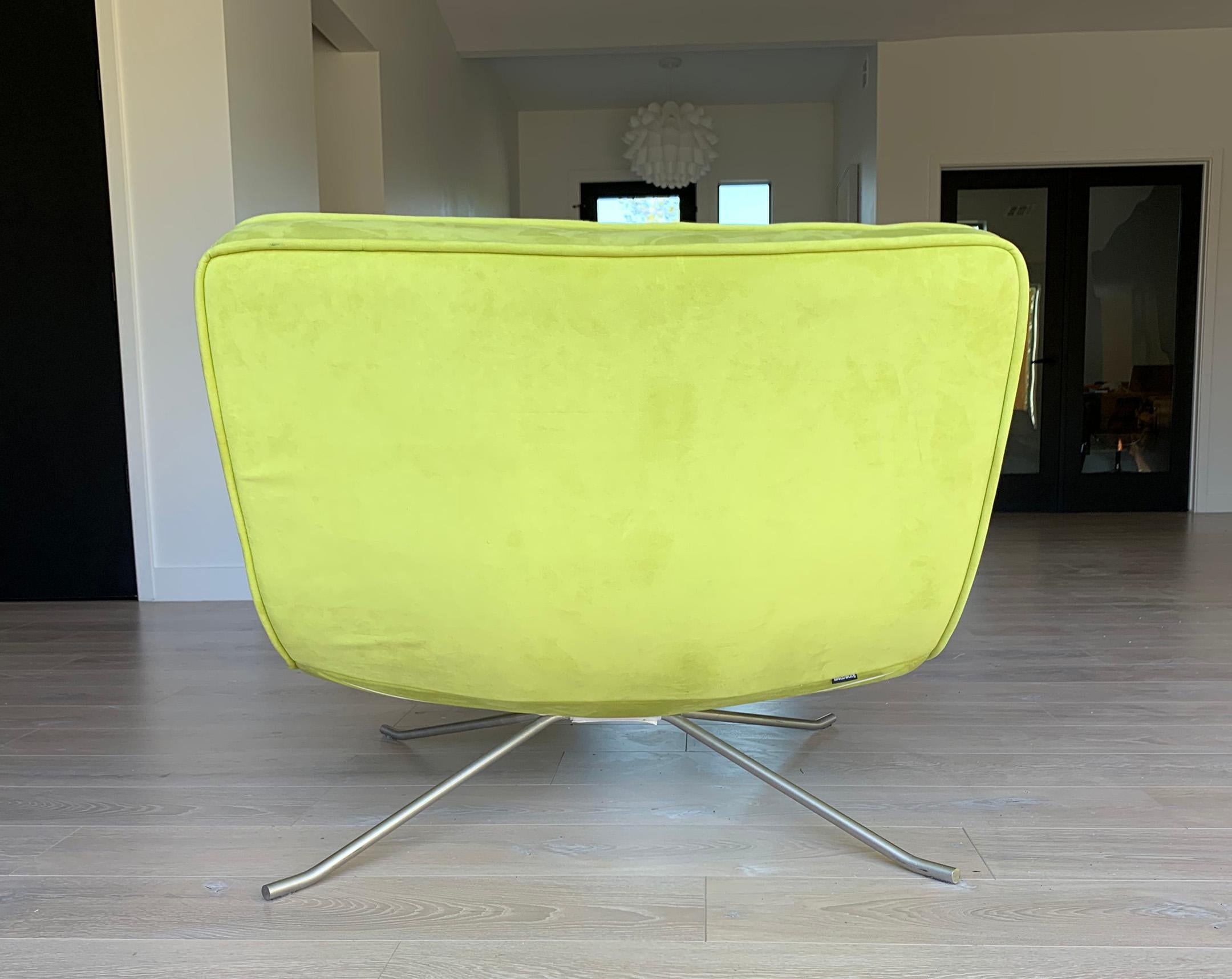 An absolutely stunning chair designed by Christian Werener for Ligne Roset, 2001. This lime green pop chair and ottoman feature curvy, clean lines with a modern feel. This transitional lounge chair would look incredible in almost any environment as