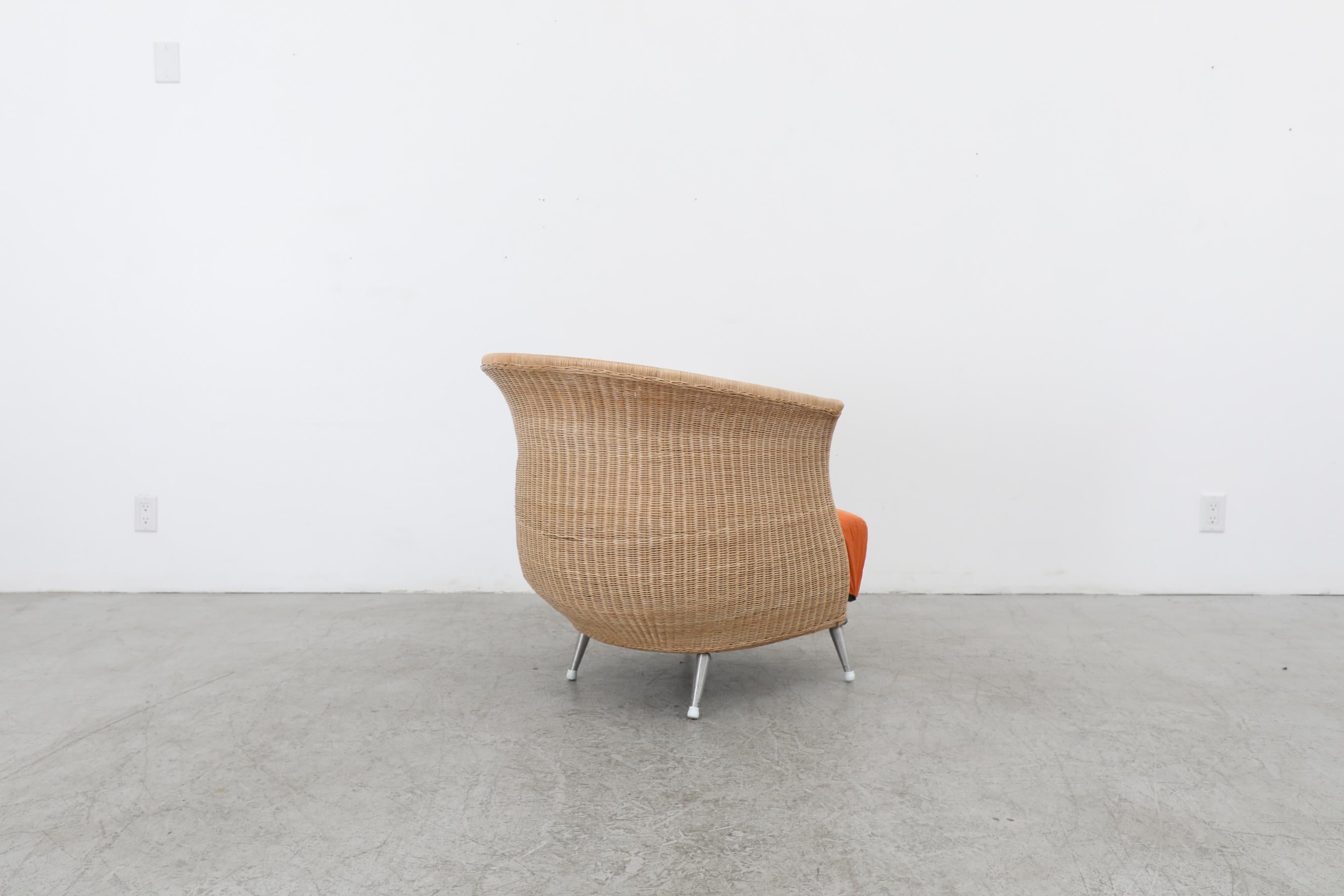 Ligne Roset Organic Shaped Rattan Lounge Chair w/ Orange Cushions & Metal Feet In Good Condition For Sale In Los Angeles, CA