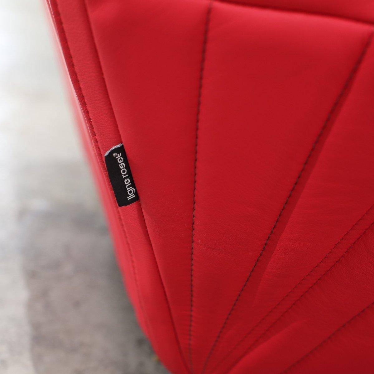 Introducing the Ligne Roset Red Facett Armchair, designed by renowned duo R. & E. Bouroullec. This stunning piece is a true statement of luxury and style, featuring a unique faceted design and a vibrant red colour that would add a pop of colour to