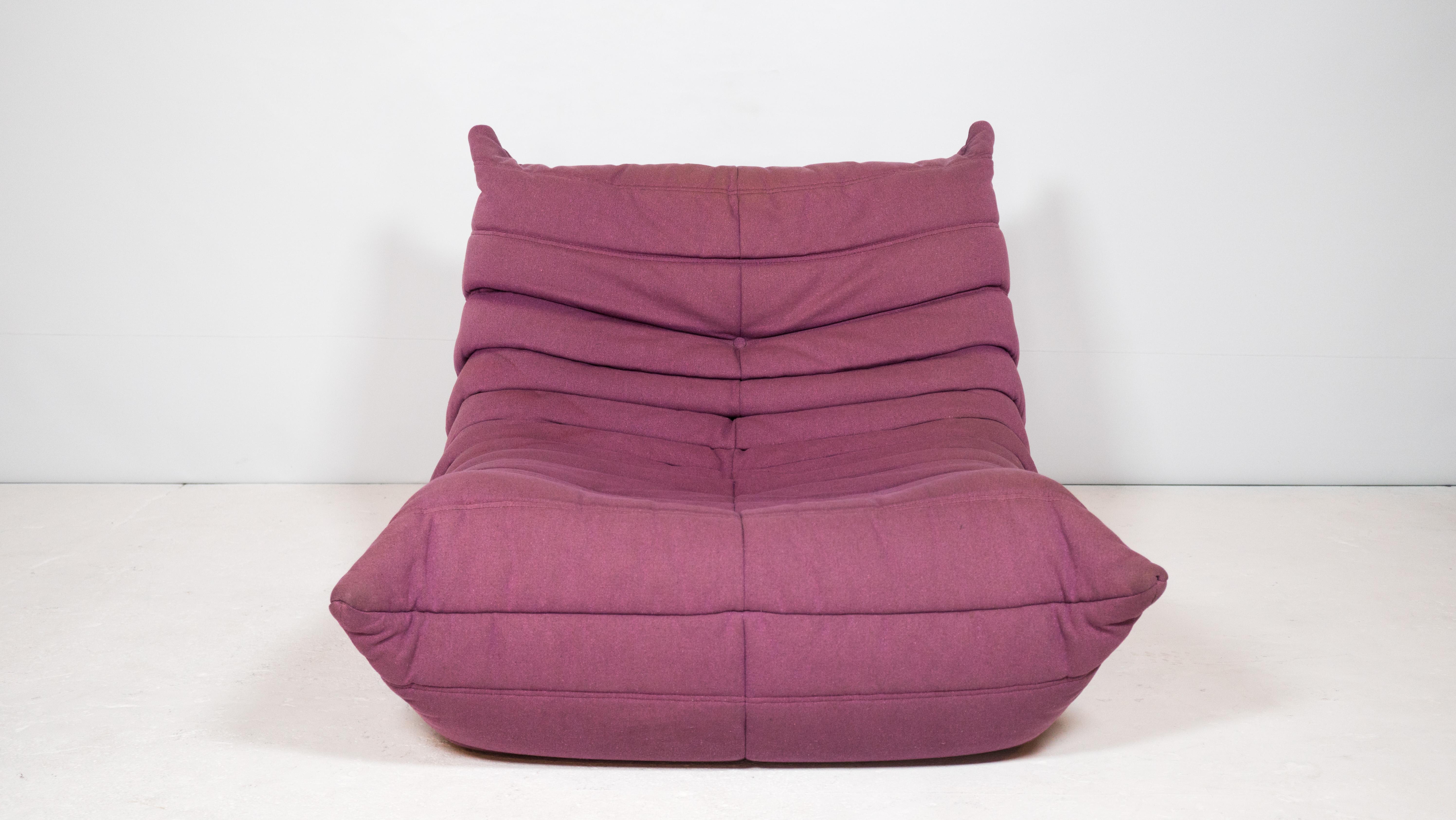 Ligne Roset Togo Fireside chair by Michel Ducaroy in original thick purple linen fabric, circa 2000s. Whimsical design and unique form that is both visually pleasing and physically inviting. Playful and engulfing seating experience. Good used