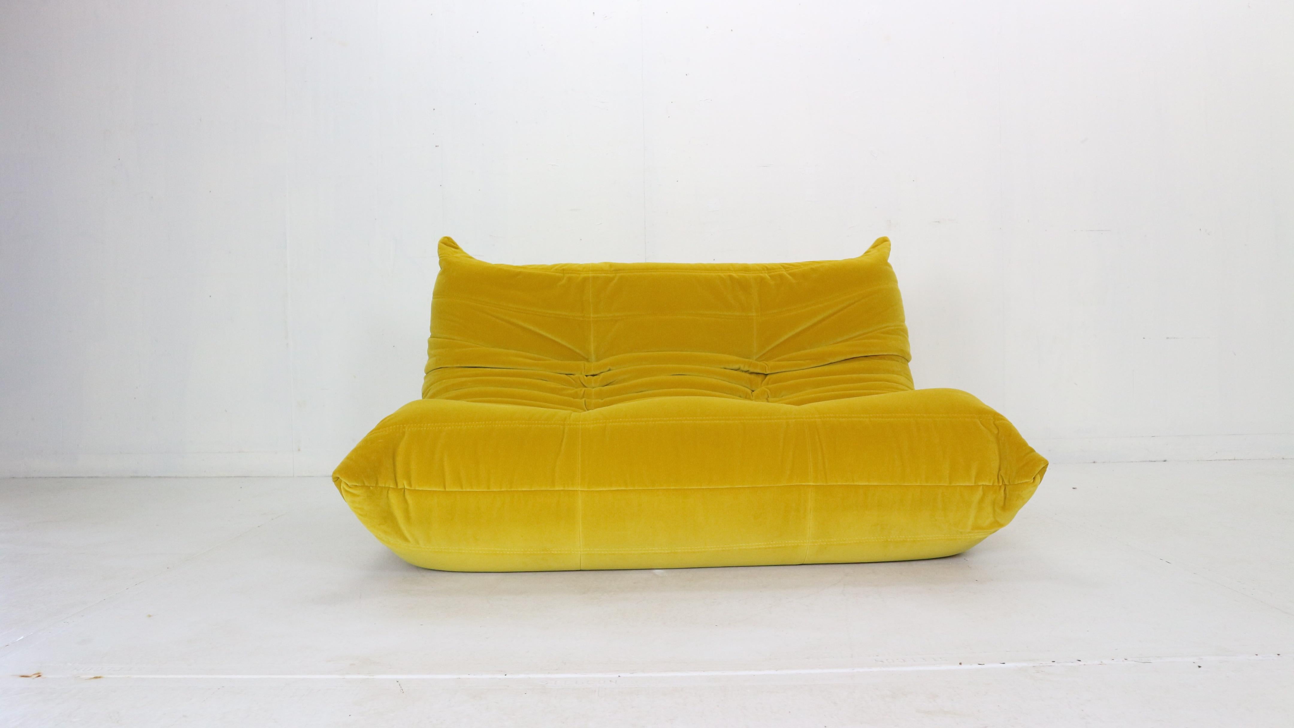 Magnificent Togo two seater lounge sofa designed by Michel Ducaroy in 1973 and was manufactured by Ligne Roset in France.
Very comfortable and beautiful accent to your living room space.
It has been newly reupholstered in yellow soft velvet